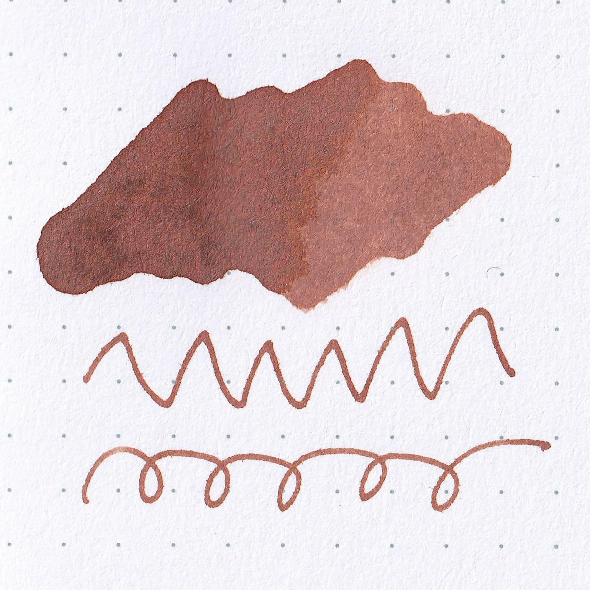 A swatch of red-brown "OPERA ROSE" ink on dotted paper, showcasing shading, part of Japanese stationery.