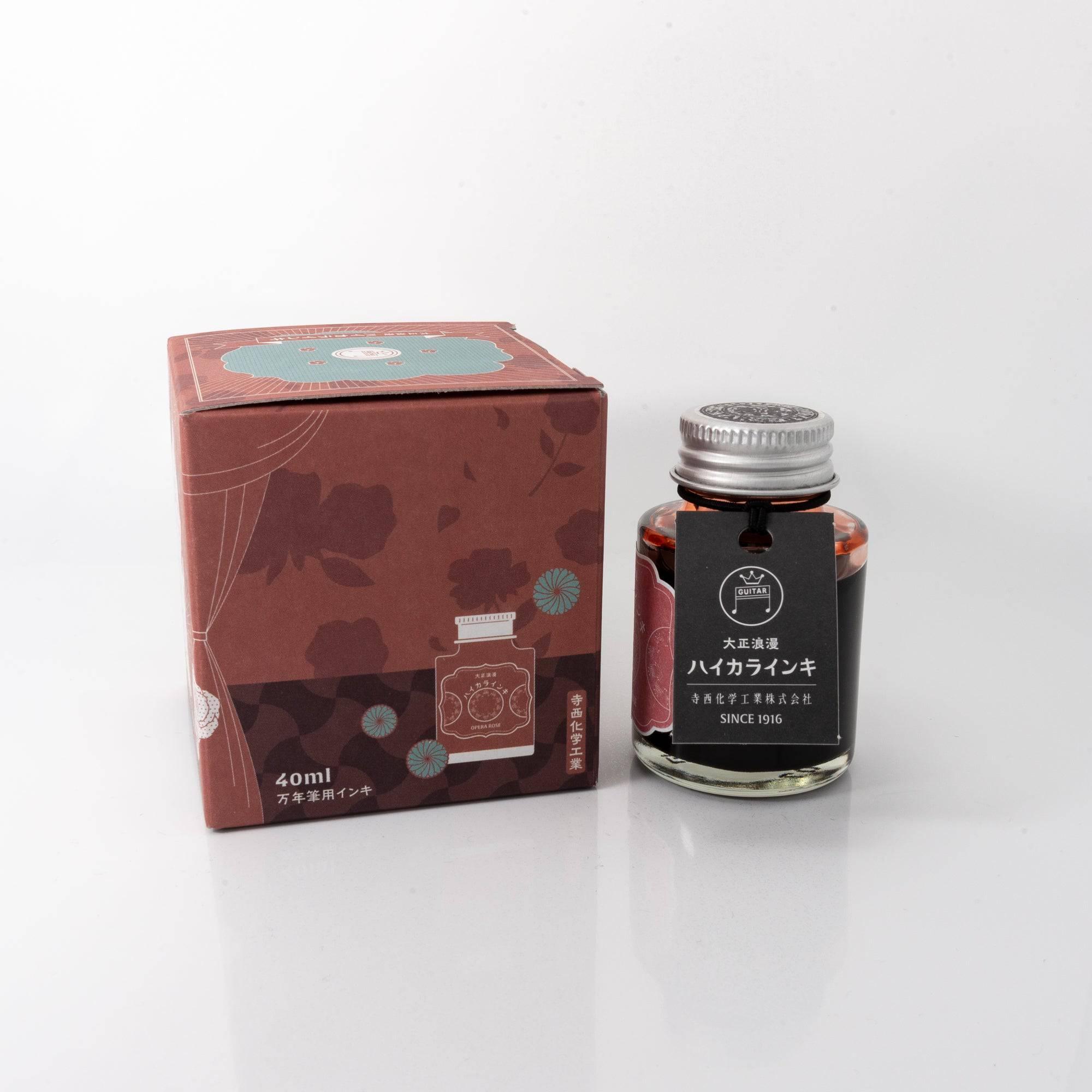 A bottle of red-toned ink "OPERA ROSE" with its box, featuring a chic design, a classic Japanese stationery item.