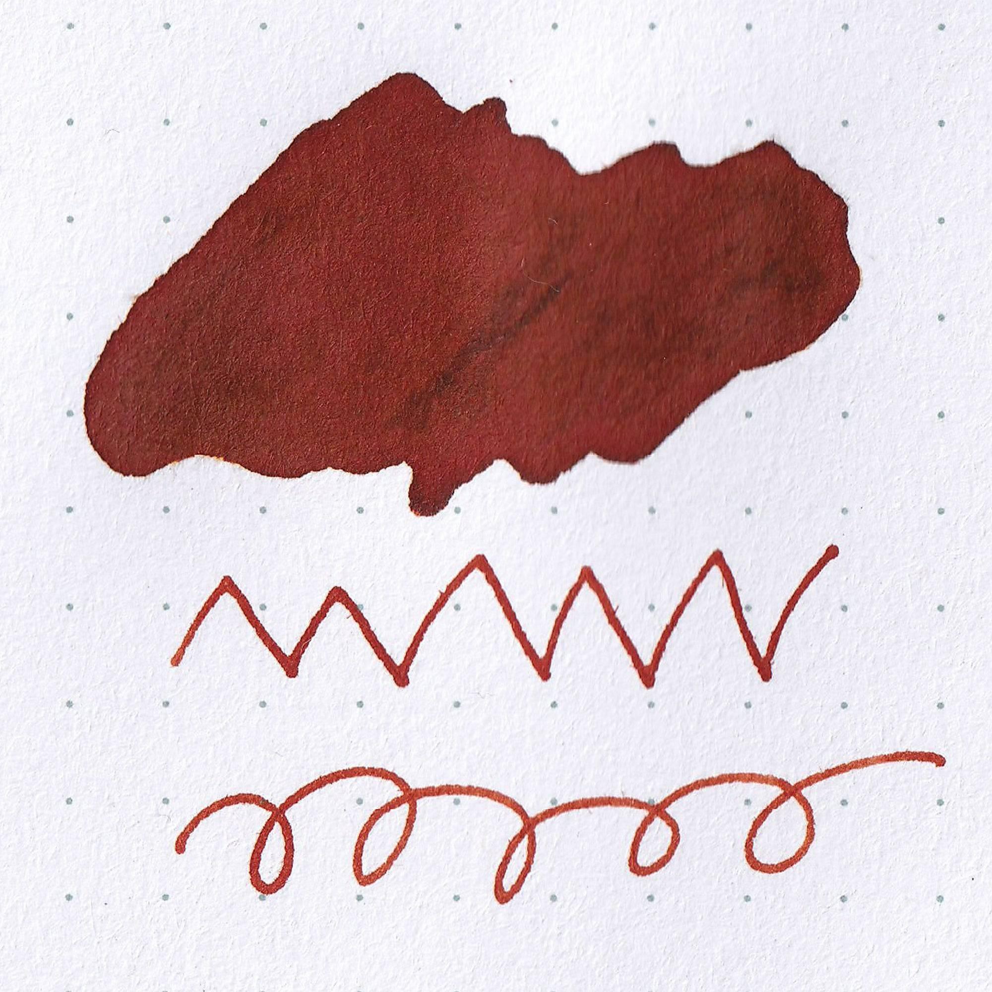 Close-up of Taisho Romance Orchestra Tangerine ink bottle, showcasing its vibrant orange ink and vintage-inspired label design.