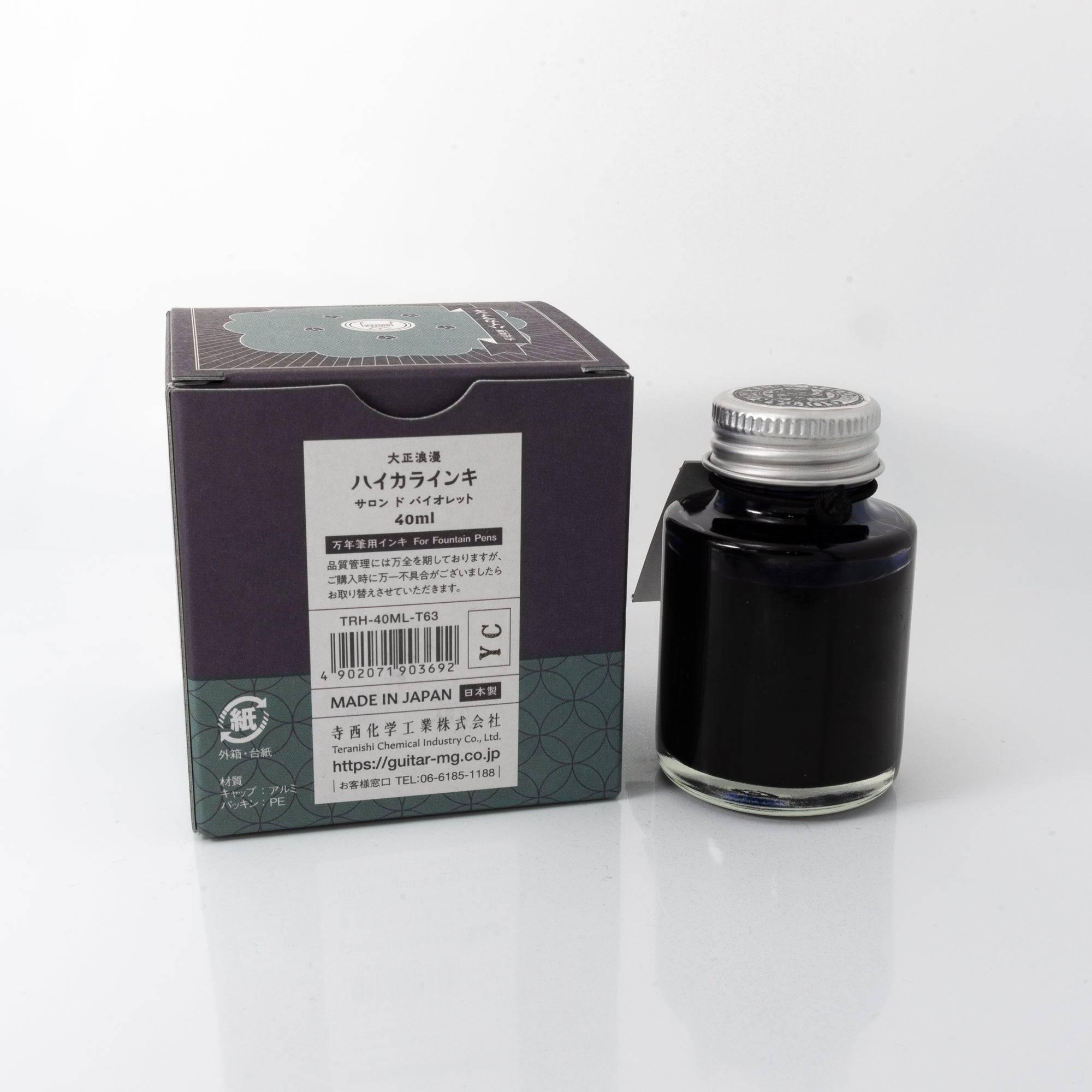 Top view of the Taisho Romance Salon de Violet ink bottle, showcasing its striking purple ink, surrounded by warm wooden textures.