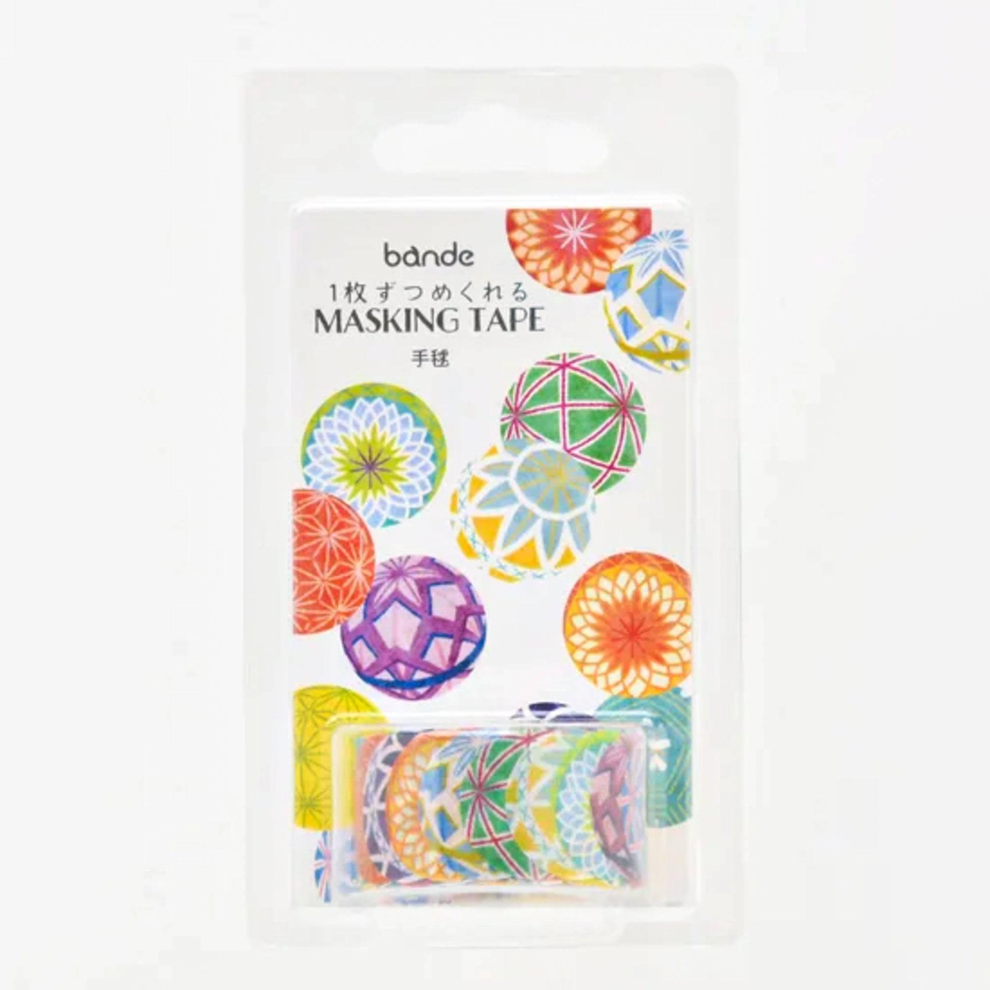 Roll of Temari Washi Tape stickers, unraveling to reveal its colorful motifs, placed on a wooden desk under soft lighting.