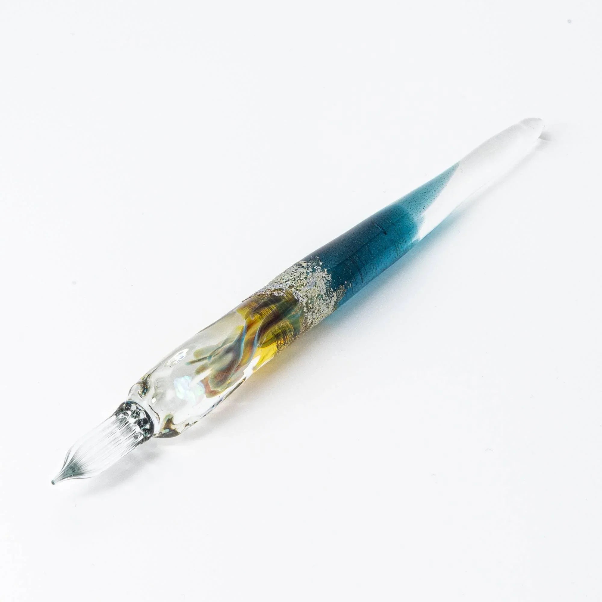 Fine detail close-up shot of deep blue glass dip pen showing precision nib craftsmanship shine
