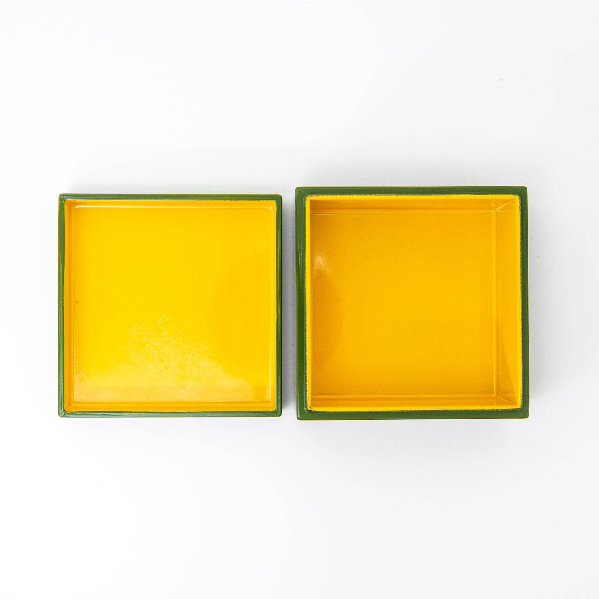 Open green Japanese lacquer stationery box separated into lid and base, both featuring a vibrant yellow interior, displayed against a clean white background.