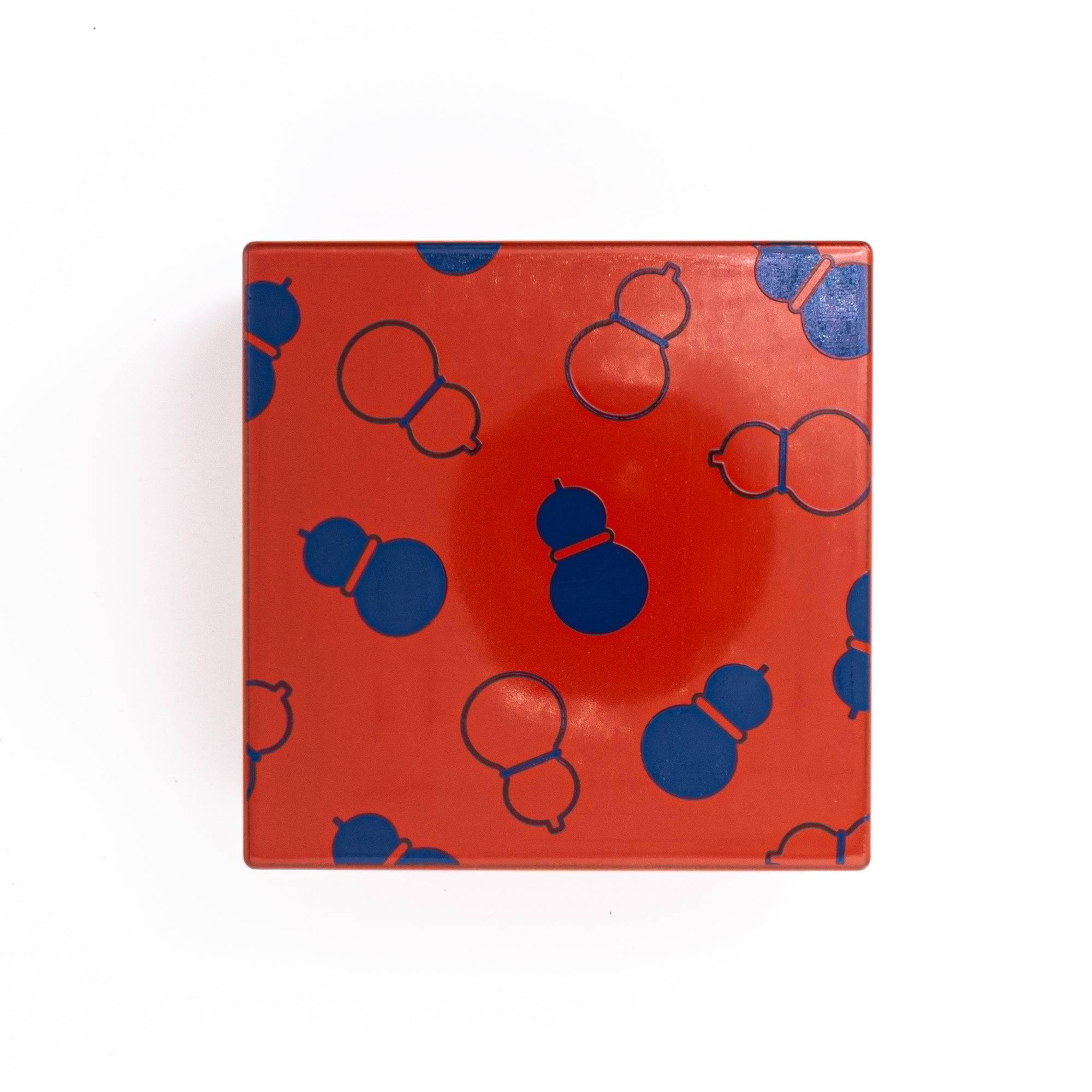 Japanese kohako gourd lacquer trinket box from above showing coral-red urushi with navy blue scattered gourd shapes