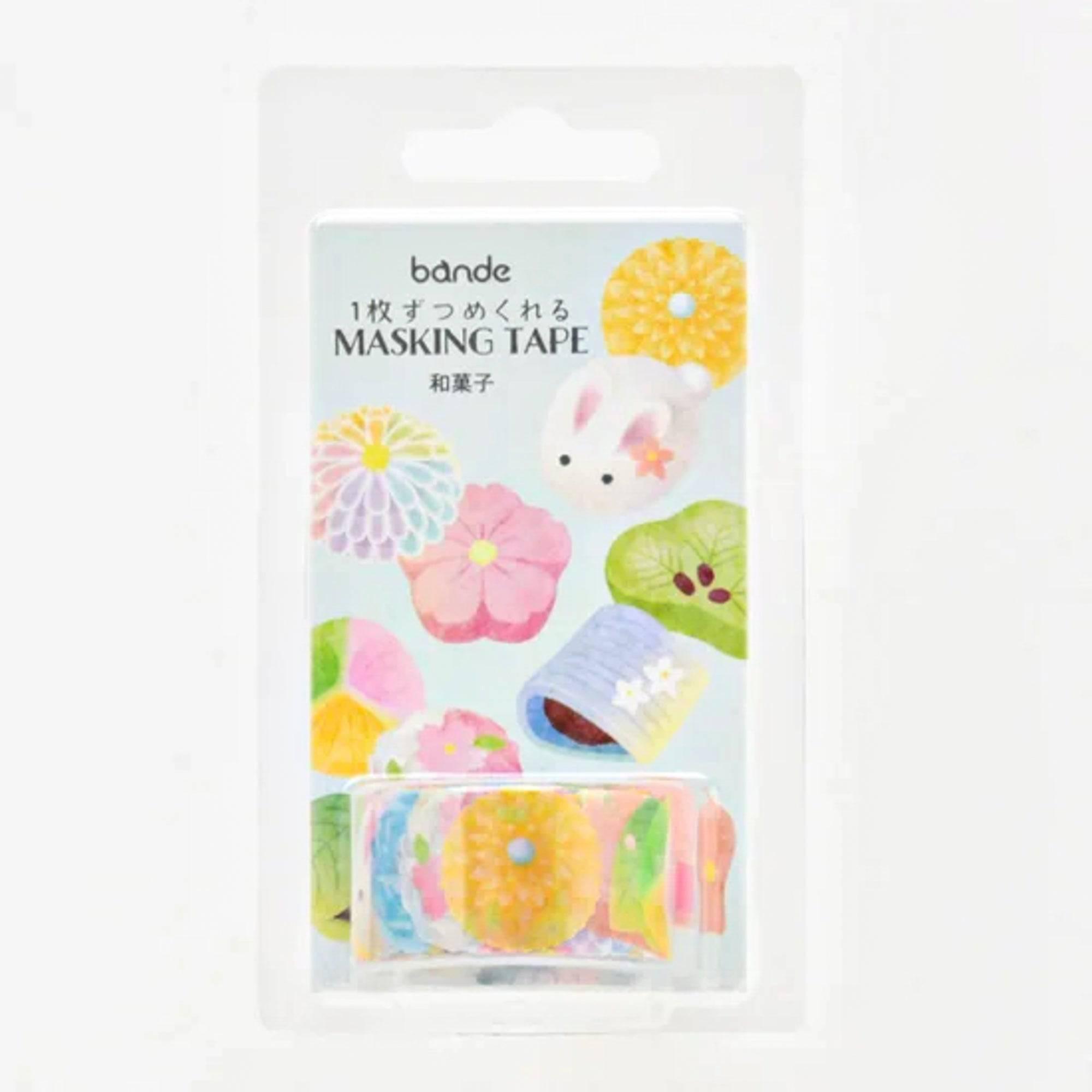 Roll of Wagashi Washi Tape stickers, unraveling to reveal its delightful Japanese dessert patterns, placed on a wooden desk under soft light.