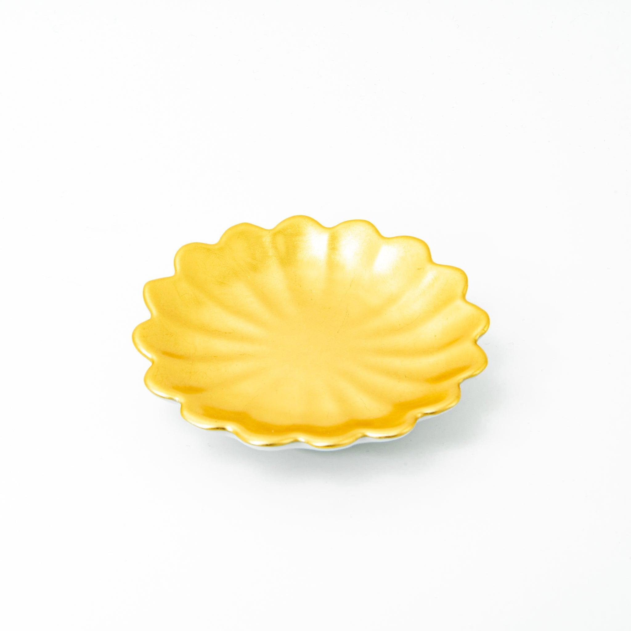 A scalloped gold ceramic dish for Japanese stationery, shown in a side profile on a white background.  