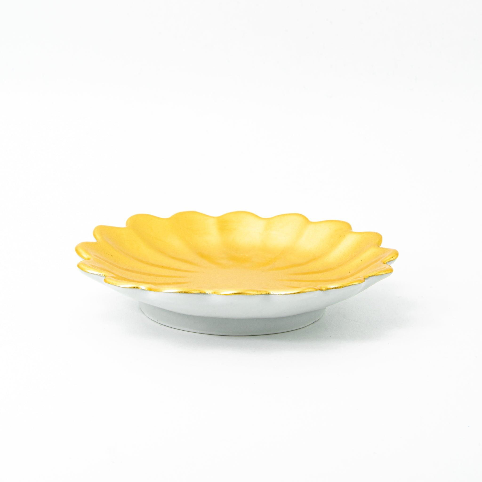 A scalloped gold ceramic dish for Japanese stationery, shown in a side profile on a white background.  