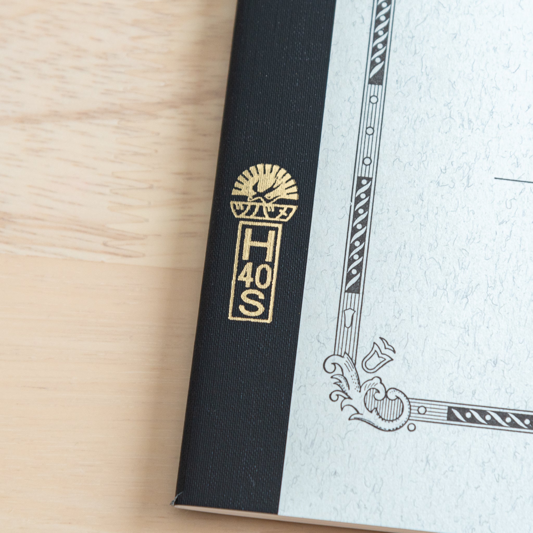 A close-up of the Tsubame Japanese notebook’s spine with gold lettering and the brand’s iconic logo, highlighting its premium Japanese stationery craftsmanship.  