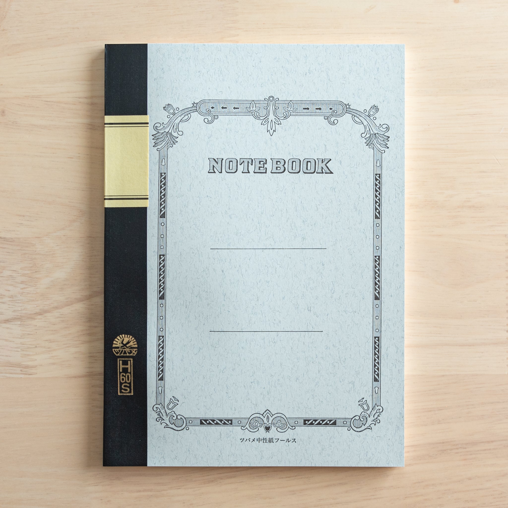 A Tsubame Japanese notebook with a decorative cover, black spine, and a gold label, showcasing the elegant and classic design of high-quality Japanese stationery.  