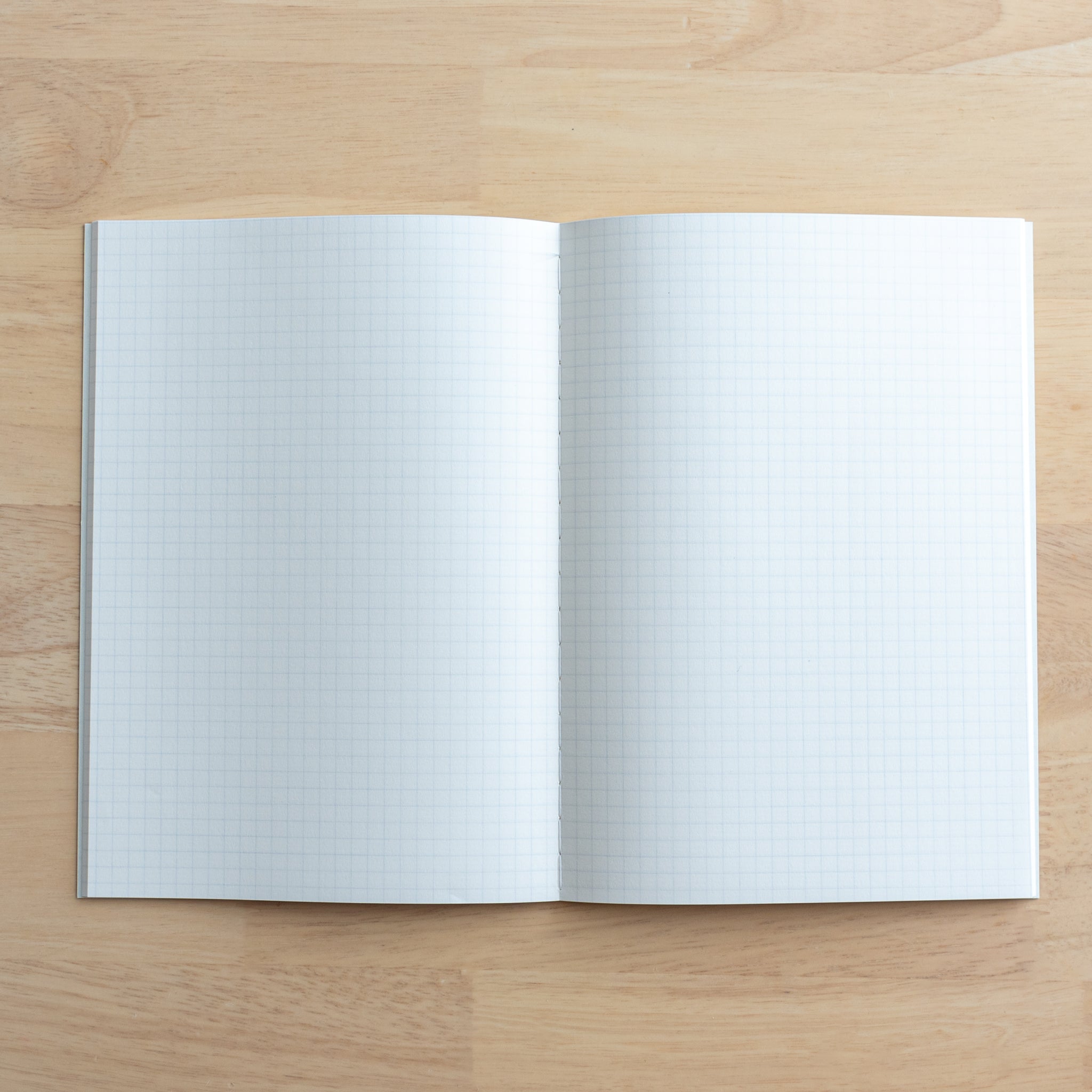 A fully opened Tsubame Japanese notebook featuring two pages of smooth grid paper, designed for writing and sketching, representing high-quality Japanese stationery.  