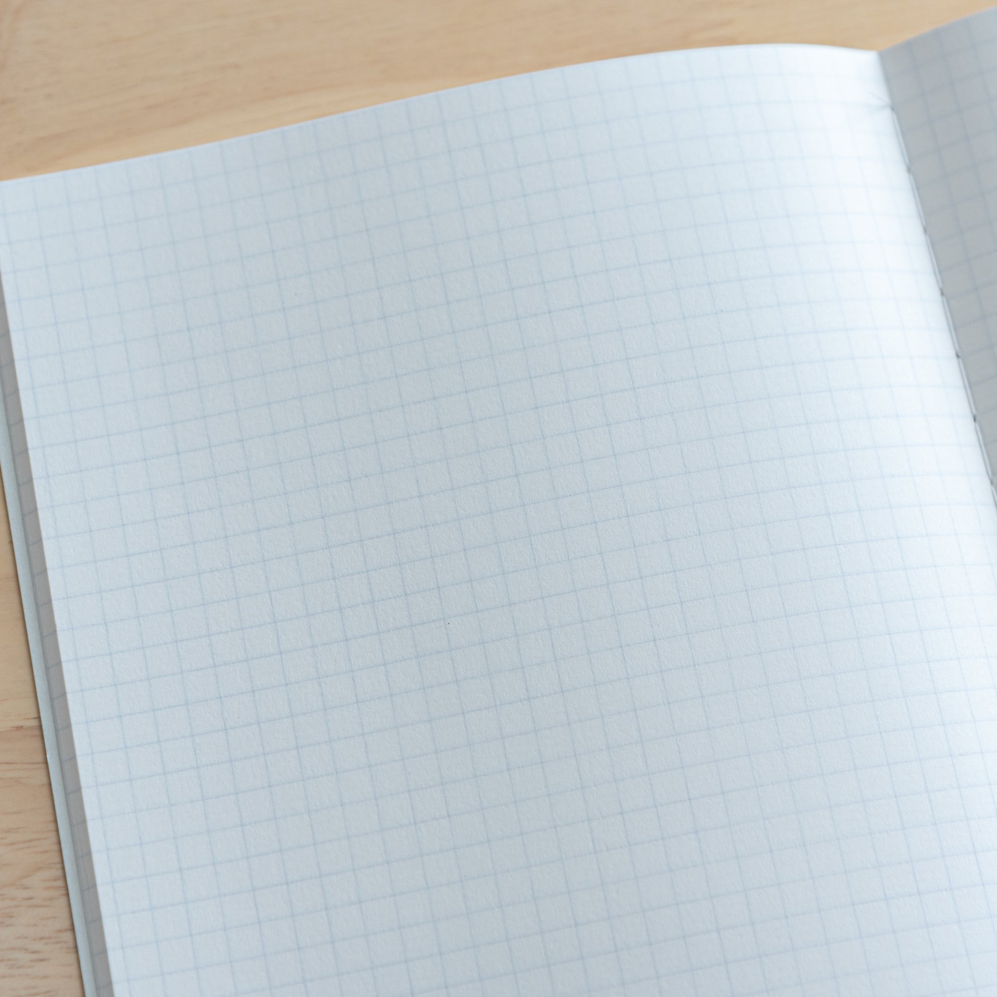 A close-up of a Tsubame Japanese notebook’s grid paper, showcasing smooth, high-quality pages ideal for writing and drawing, part of premium Japanese stationery.  