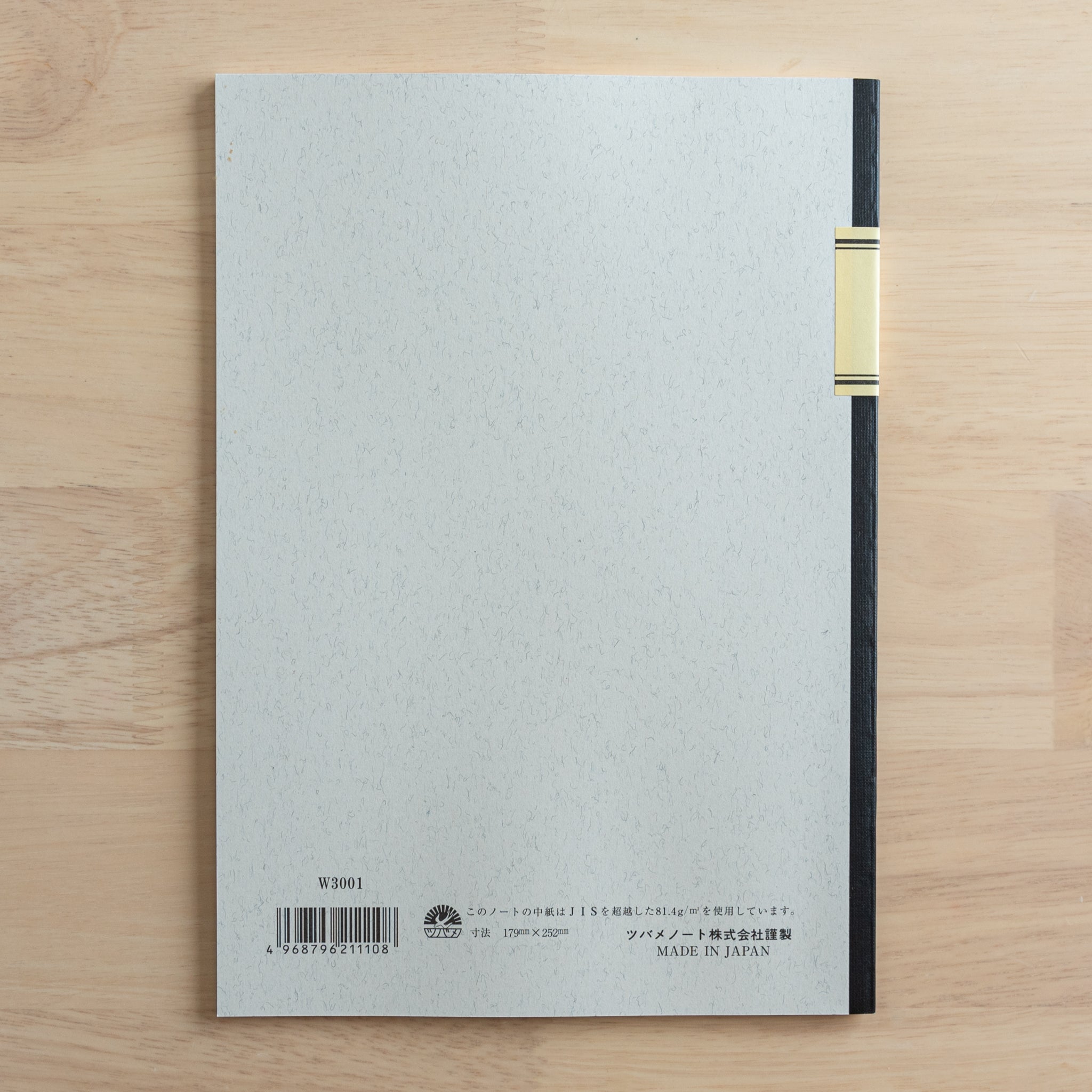 The back cover of a Tsubame Japanese notebook with a black spine, featuring product details, a barcode, and "Made in Japan" text, representing fine Japanese stationery.  