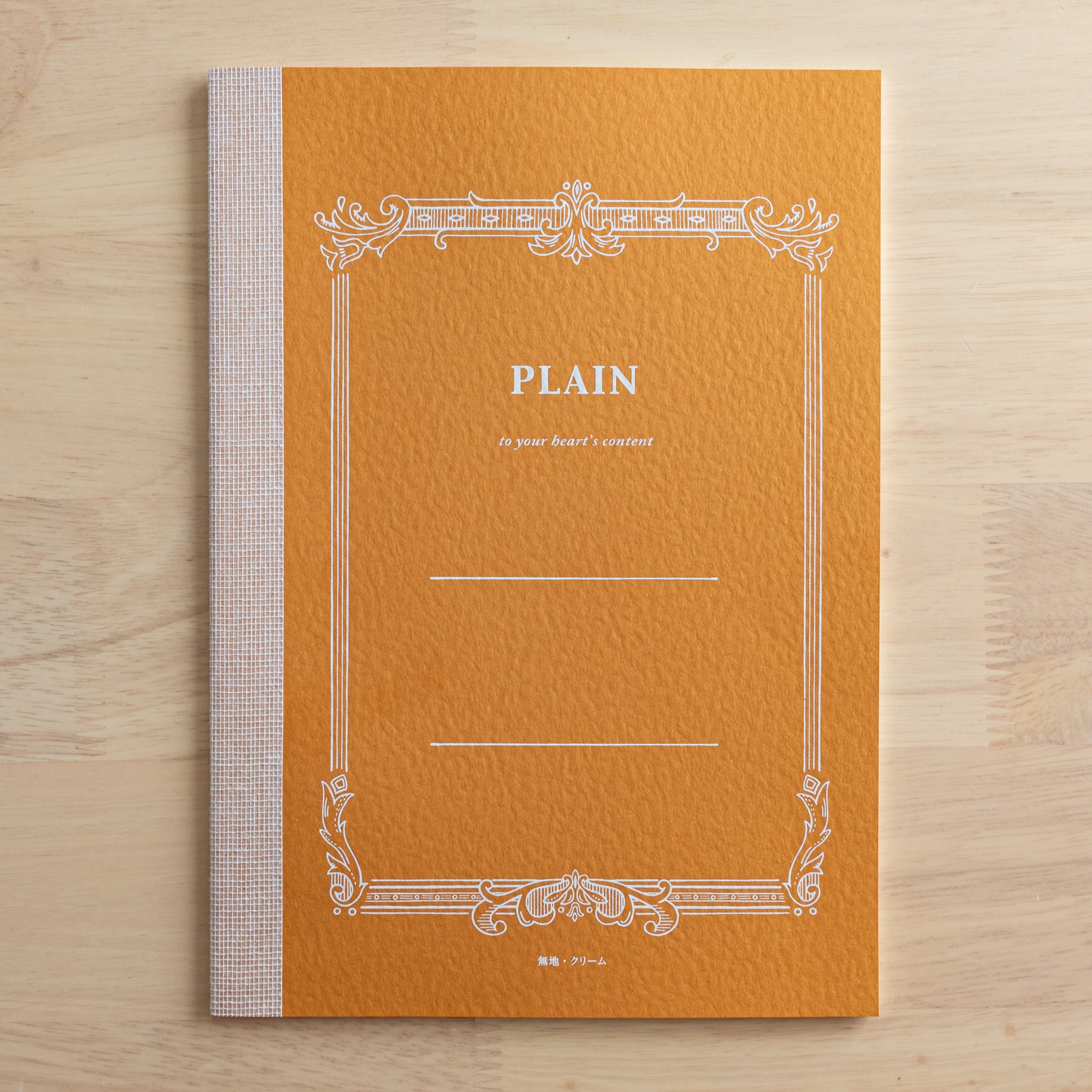 A single orange Tsubame Japanese notebook labeled "Plain" with an ornate border. A beautiful example of traditional Japanese stationery.