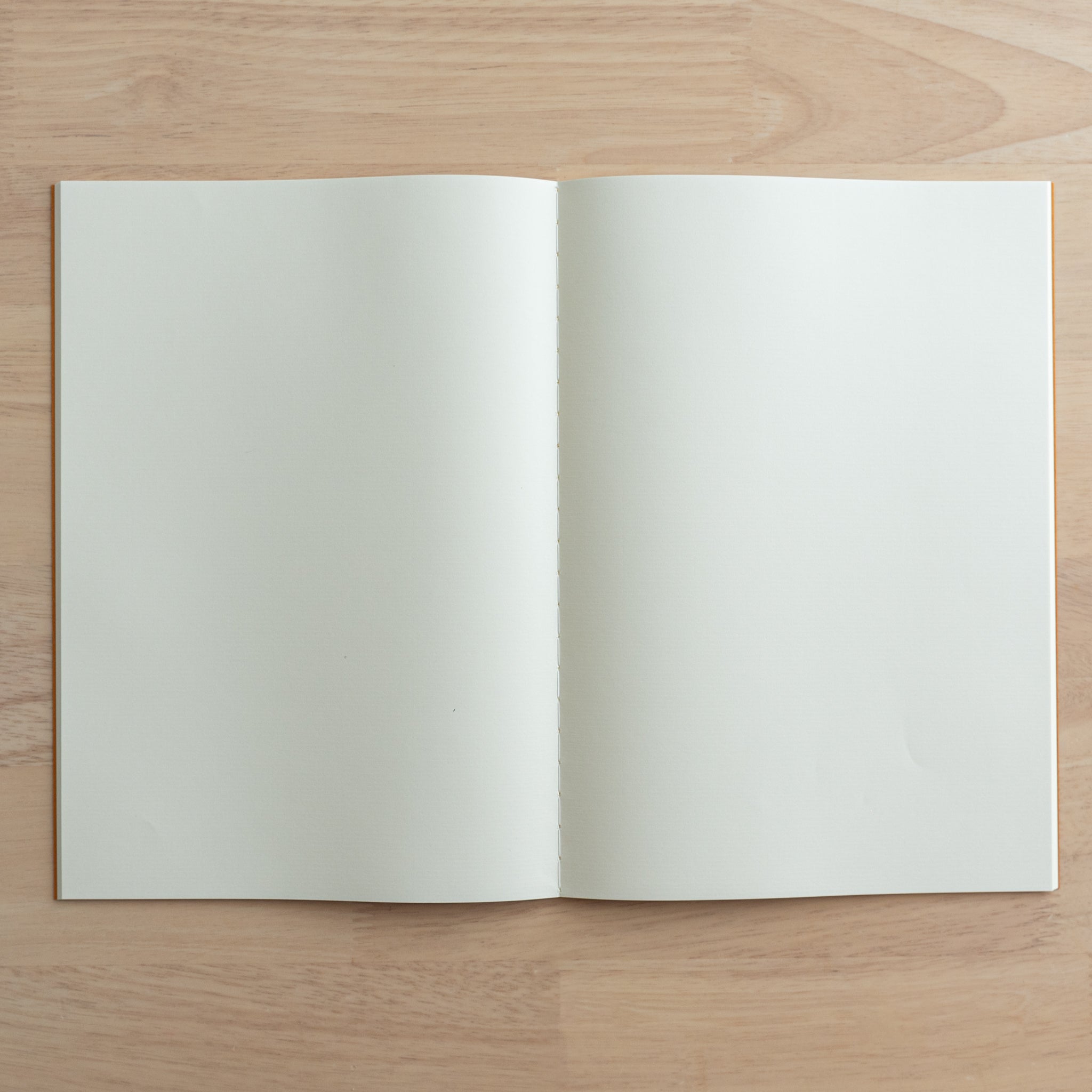 A fully opened Tsubame Japanese notebook displaying blank cream-colored pages, ideal for writing or drawing. A refined piece of Japanese stationery.