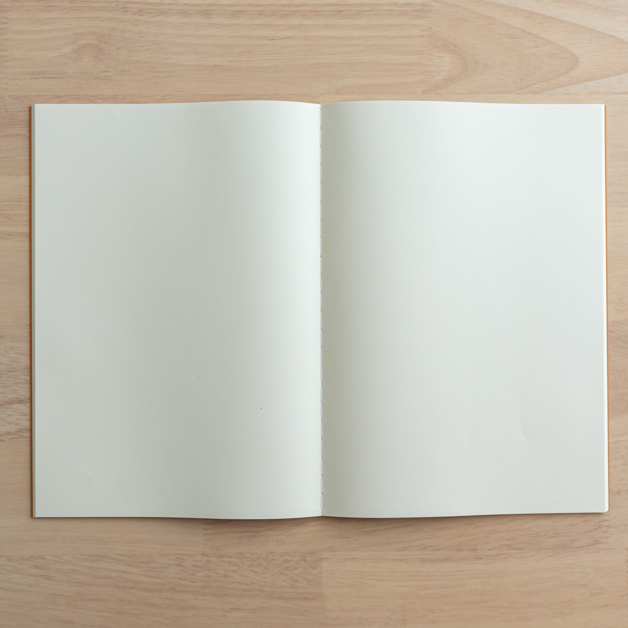 A fully opened Tsubame Japanese notebook displaying blank cream-colored pages, ideal for writing or drawing. A refined piece of Japanese stationery.