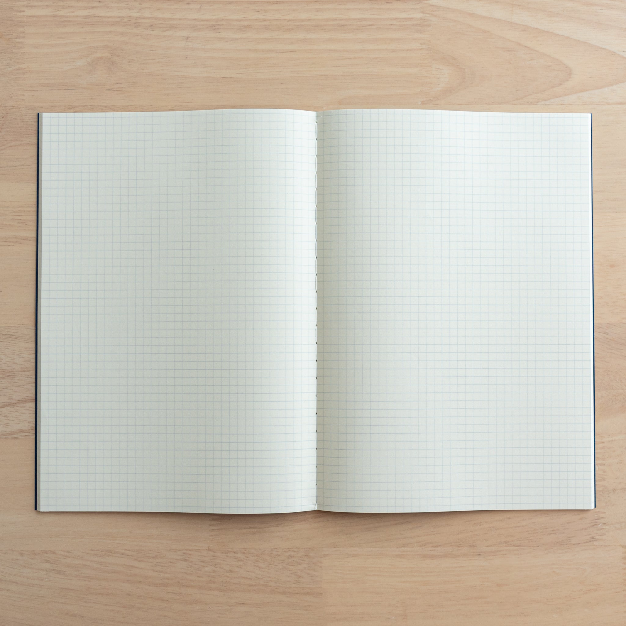 A fully opened Tsubame Japanese notebook displaying grid-lined cream paper, ideal for neat writing and organization. A classic in Japanese stationery.