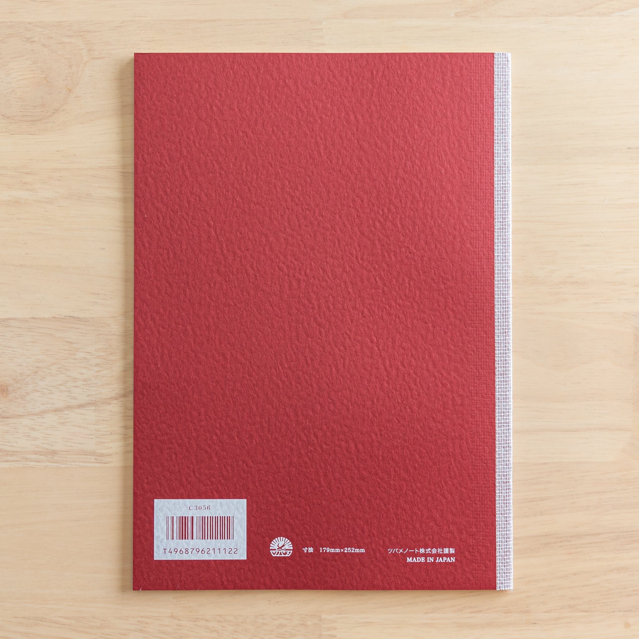 The back cover of a Tsubame Japanese notebook with a red textured finish, barcode, and "Made in Japan" label. A classic in Japanese stationery.