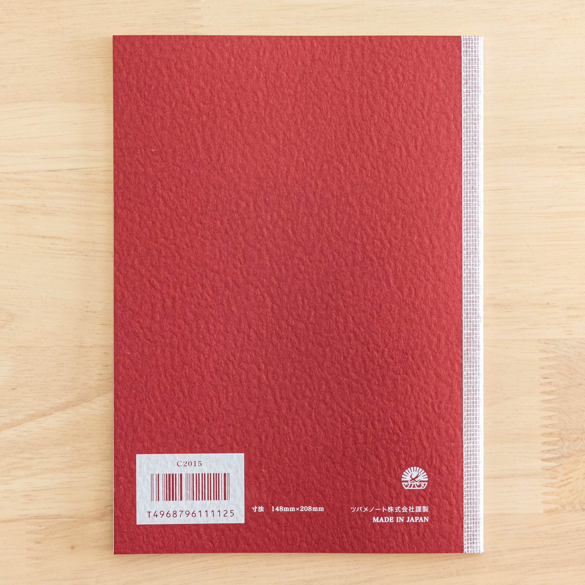 The back cover of a Tsubame Japanese notebook with a red textured finish, barcode, and "Made in Japan" label. A classic in Japanese stationery.