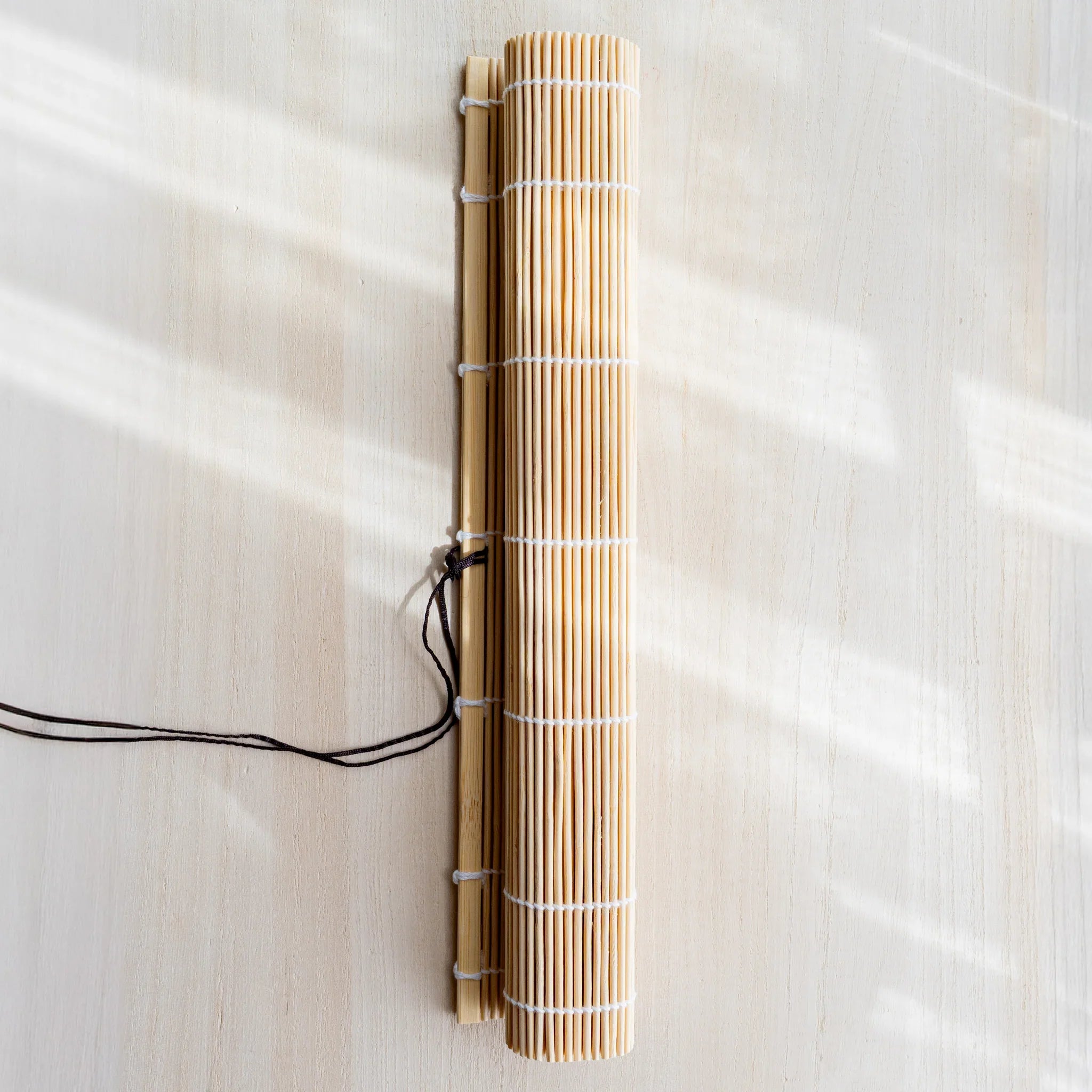 Akashiya fudemaki brush holder with natural bamboo strips and white string binding