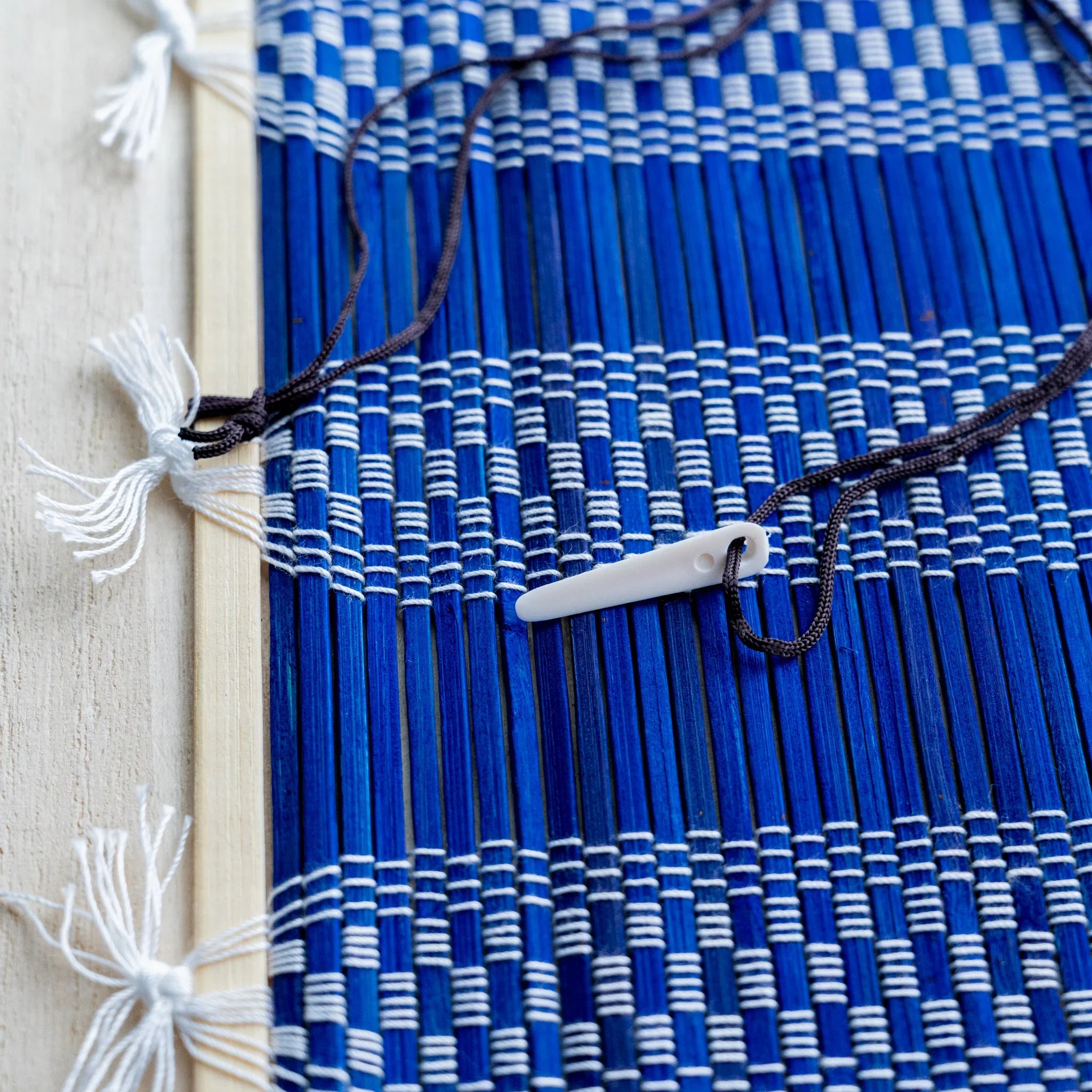Akashiya bamboo brush wrap, blue checkered weave with fringed tassel edges