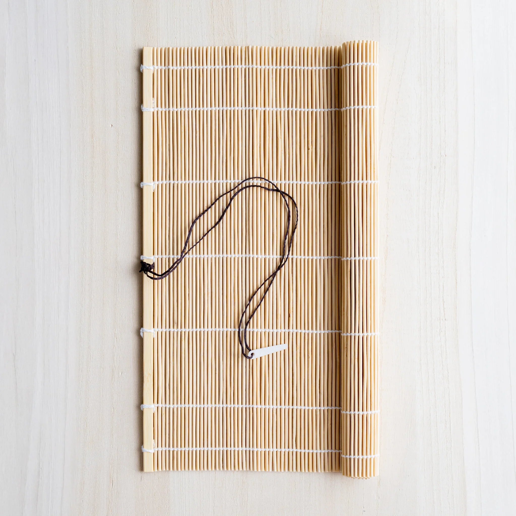 Akashiya bamboo brush holder roll, natural beige variant with traditional white binding