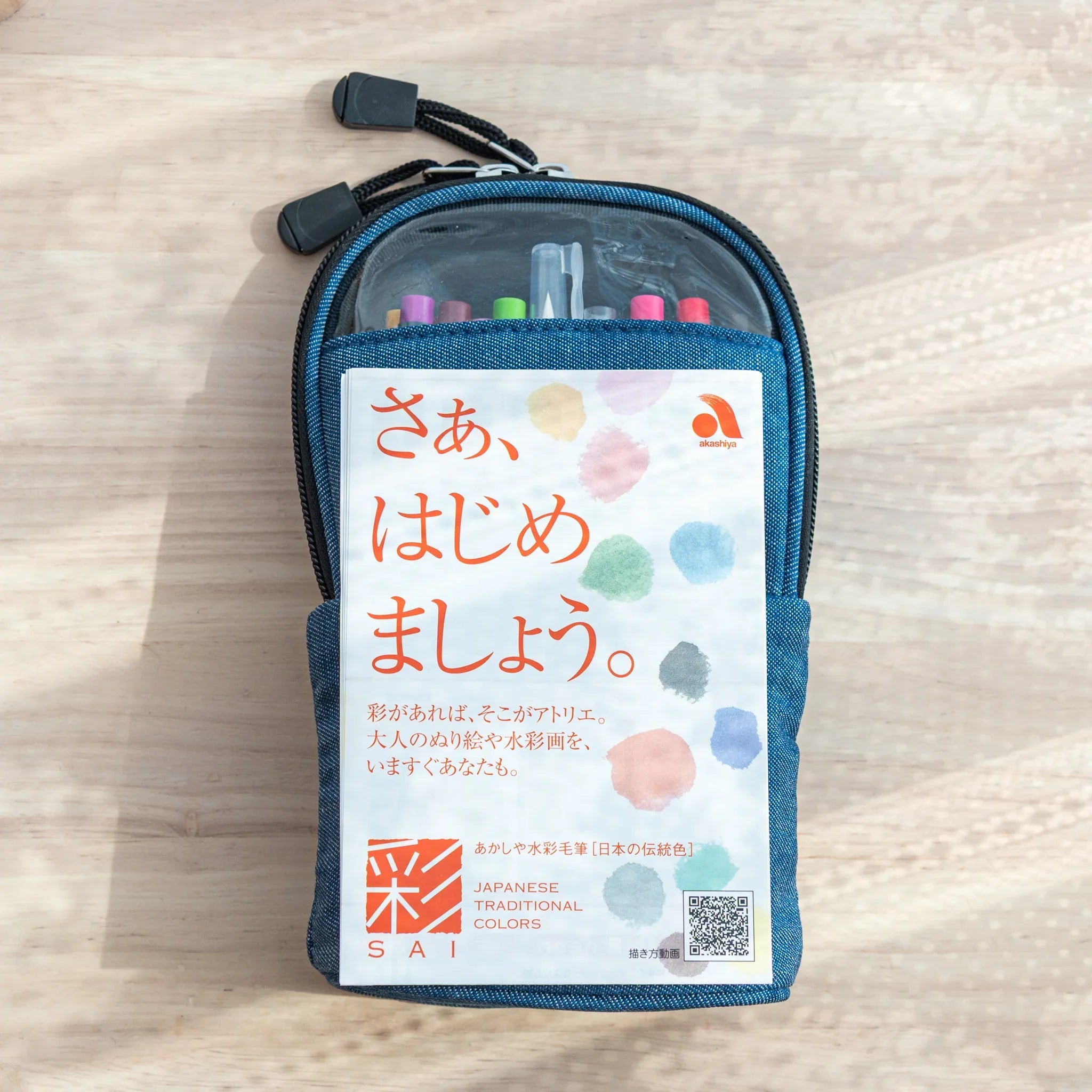 Akashiya Sai Sketch Set in denim case with colorful brush pens and Japanese leaflet, ideal for arts and crafts use.