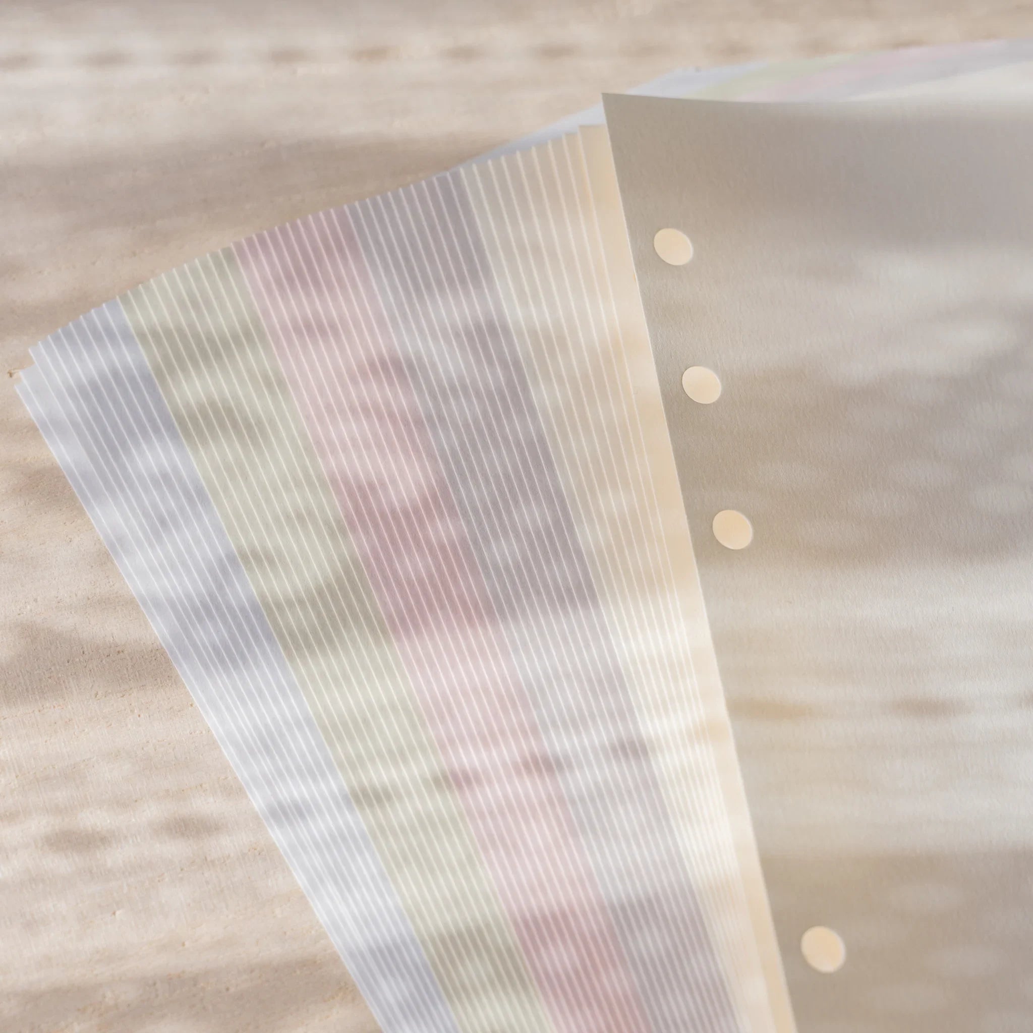 Translucent Araveal planner refill sheet with watermark stripe pattern over multi-color sheets in Bible size.
