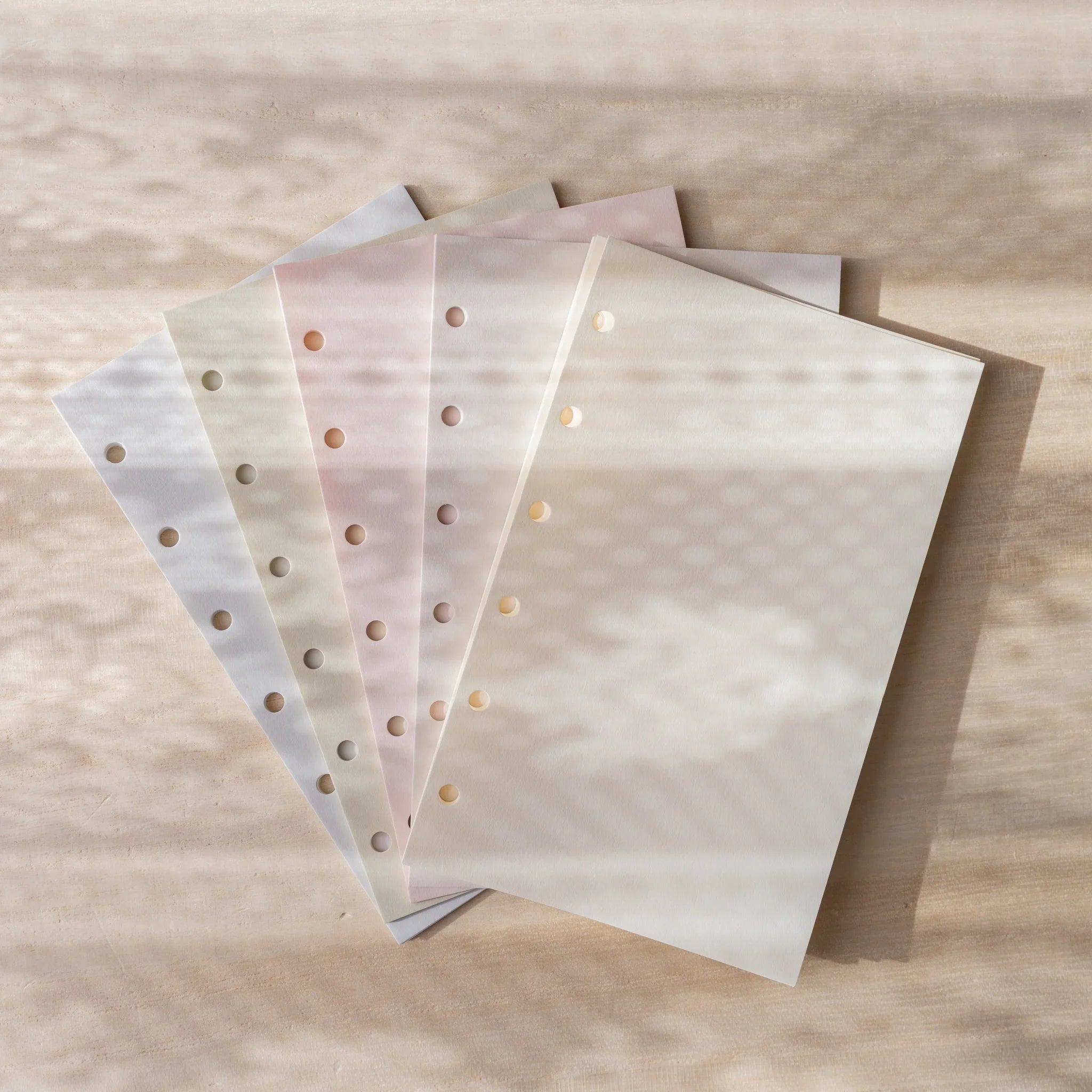 Five Araveal Mini 6 planner refill colors fanned out: natural, ash gray, primrose, sage green, and slate blue.