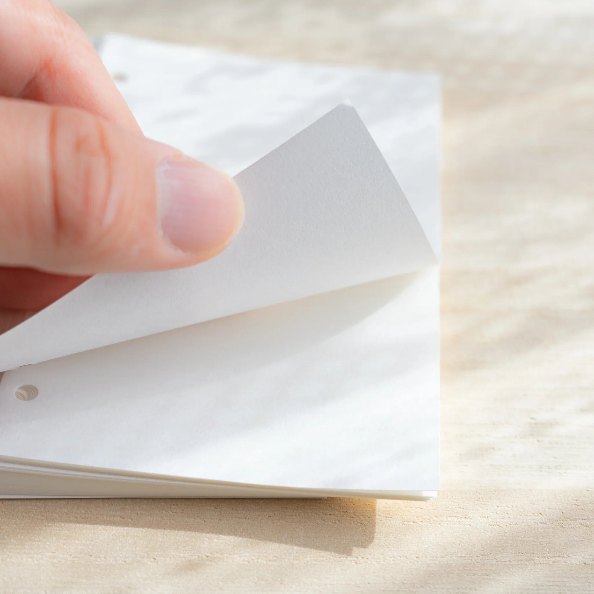 Japanese Stationery bank paper mini 6 refill sheet being lifted to show its thin texture.