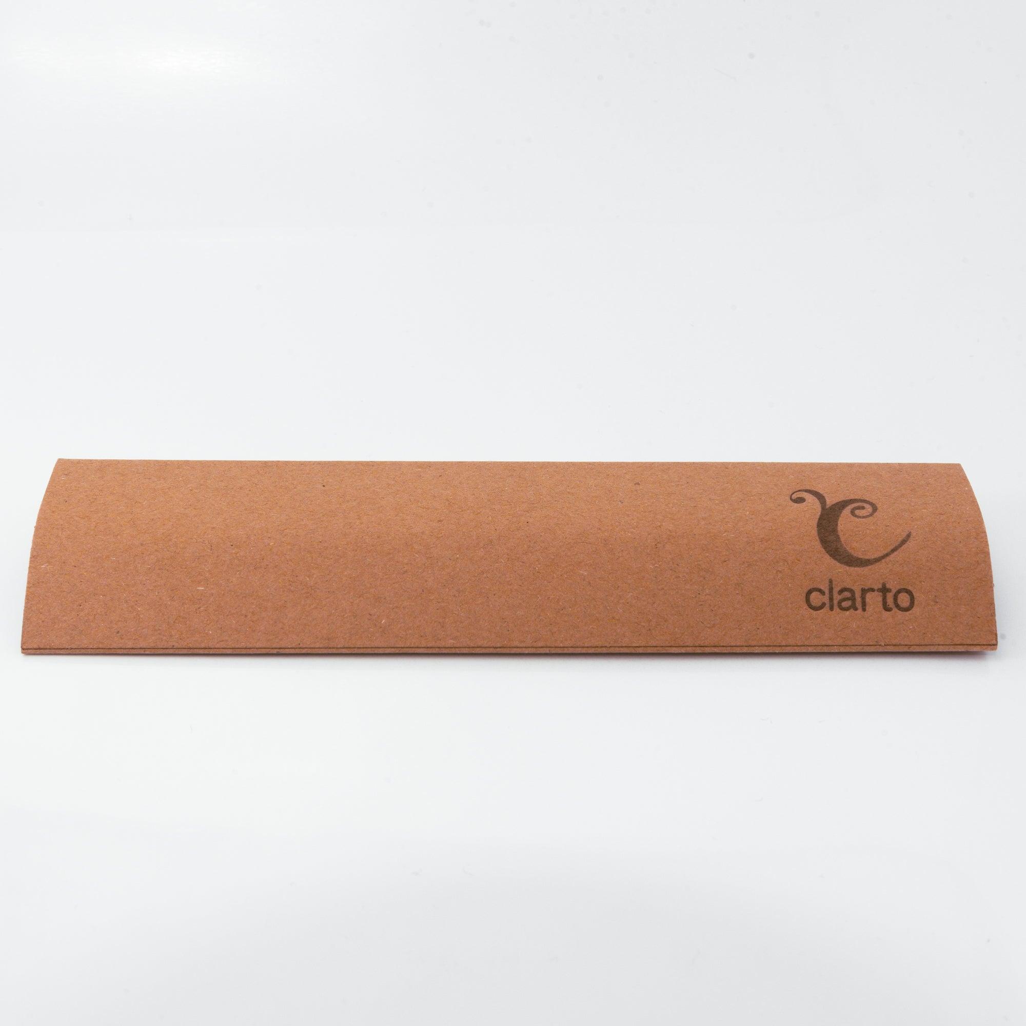 Brown kraft paper packaging featuring a printed ruler, with the tip of a glass dip pen peeking out.