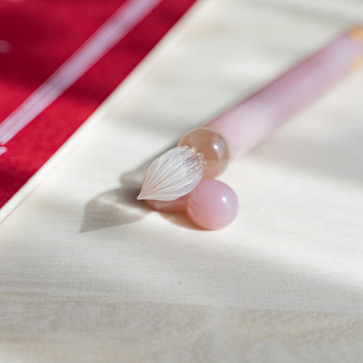 Blush Pink Flowers glass dip pen nib angled down between two pale pink glass pen rest spheres