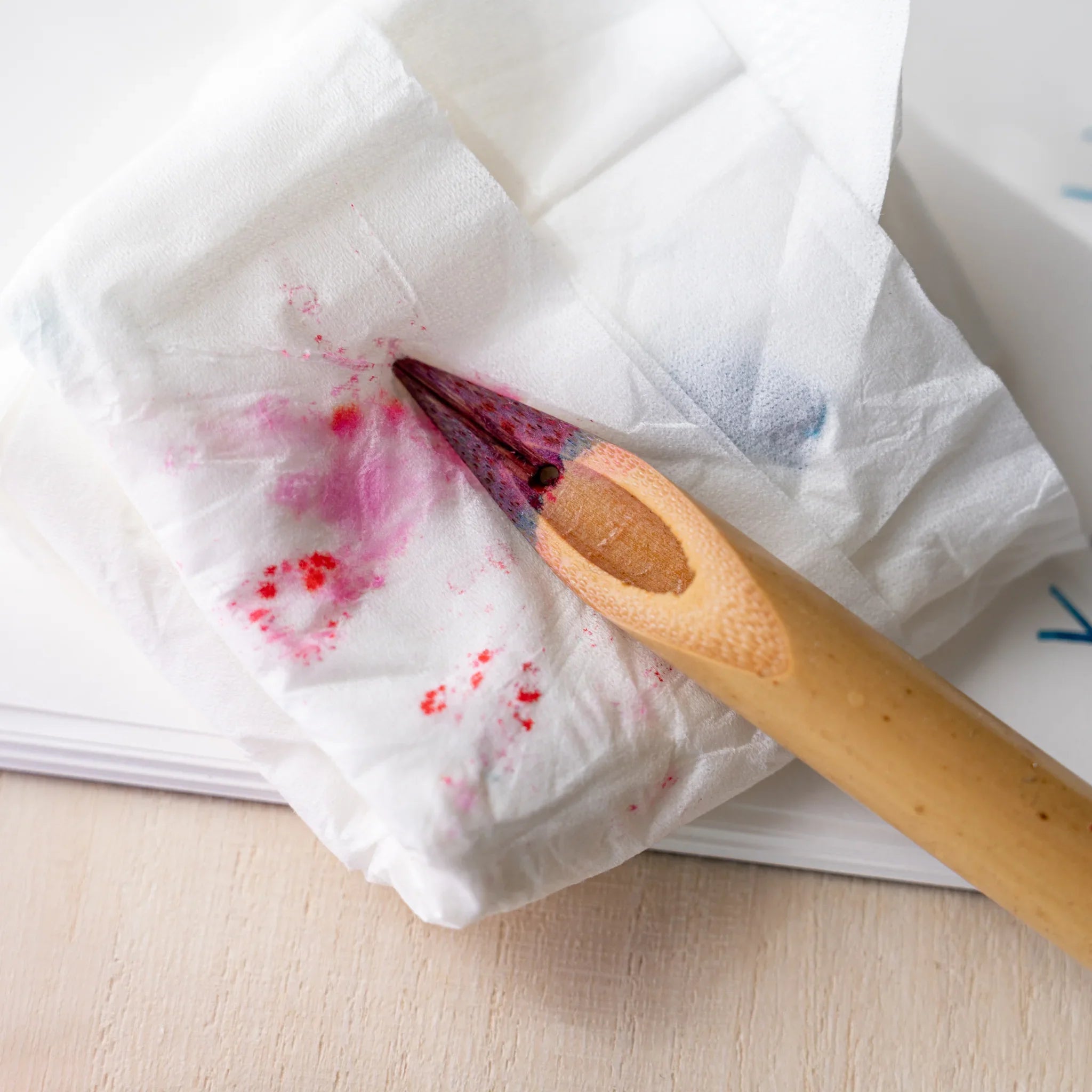 Boku-Undo bamboo dip pen nib resting on white tissue stained with red and blue ink after drying