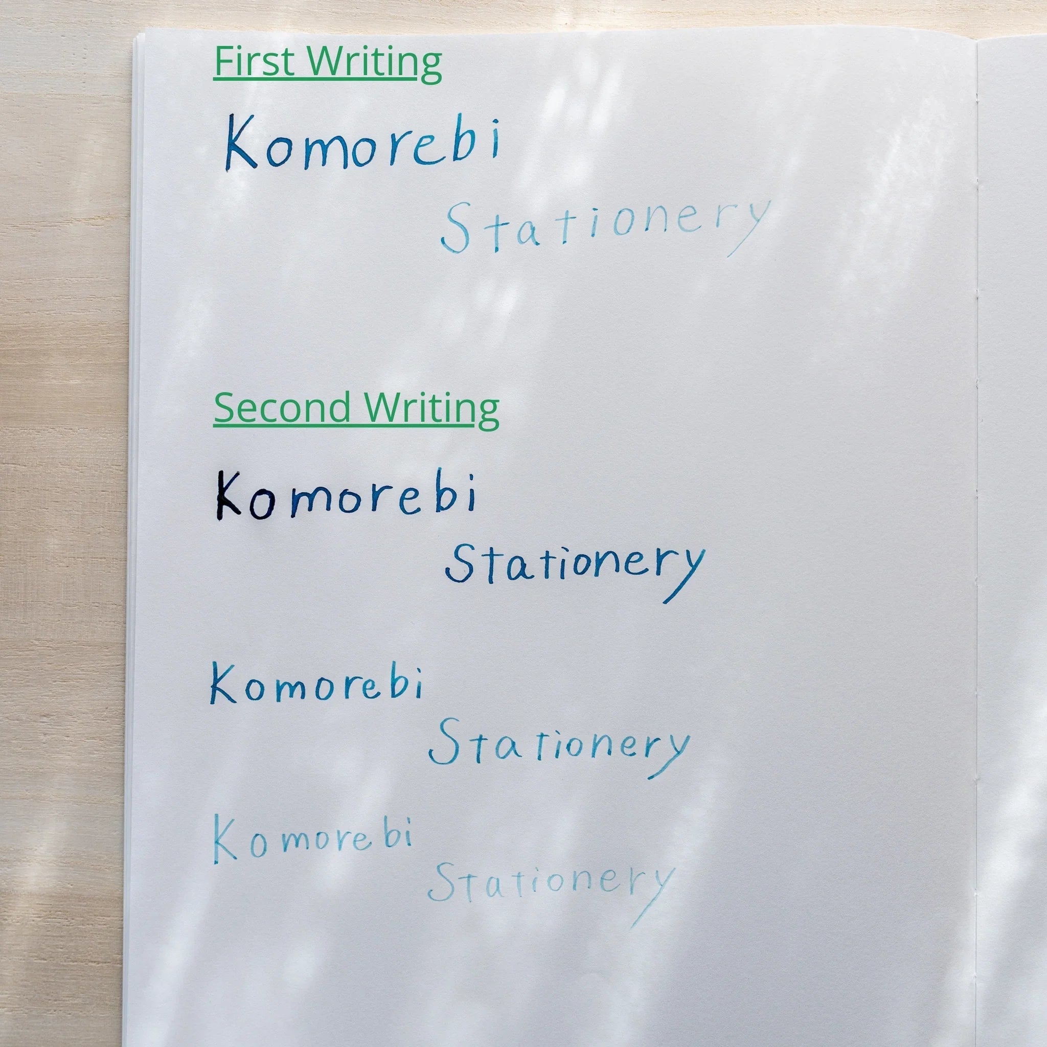 Paper showing ink test lines labeled First Writing and Second Writing with Komorebi Stationery written multiple times