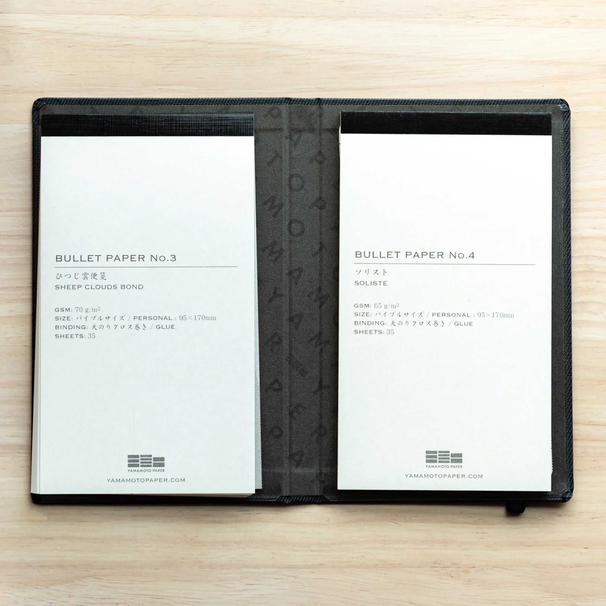 Bullet Jotter black gabardine cover open, two pads: No.3 Sheep Clouds Bond left, No.4 Soliste right, back labels showing