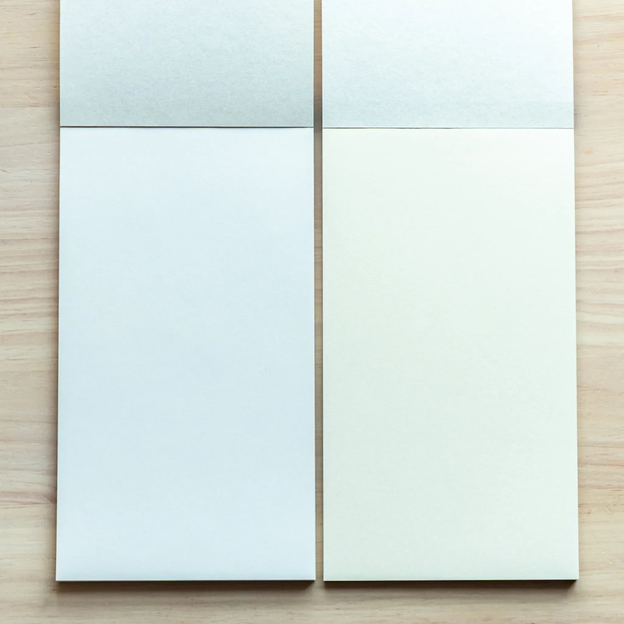 Two open refill pads side by side, blank pages of Japanese Writing Pad in white and cream.