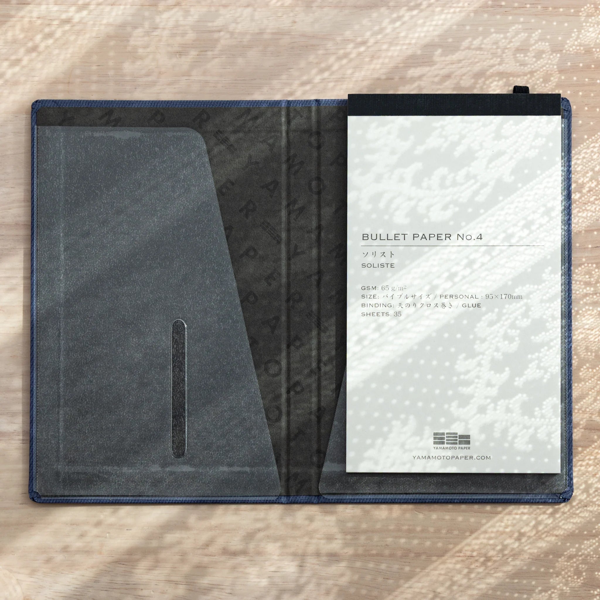 Bullet Jotter cover open showing BULLET PAPER No.4 Soliste pad on right, empty clear pocket on left, black pen loop at top