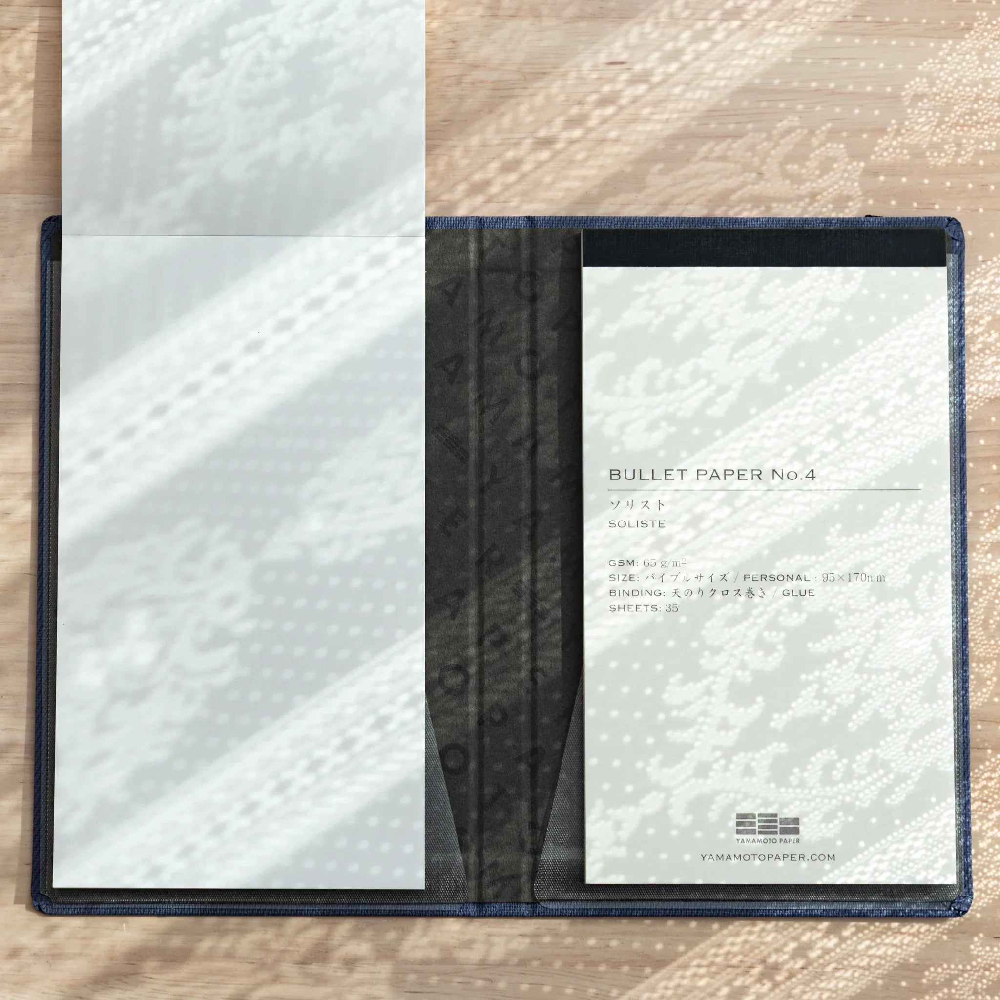 Bullet Jotter cover open flat 180 degrees, blank white pad on left, BULLET PAPER No.4 Soliste in right clear pocket