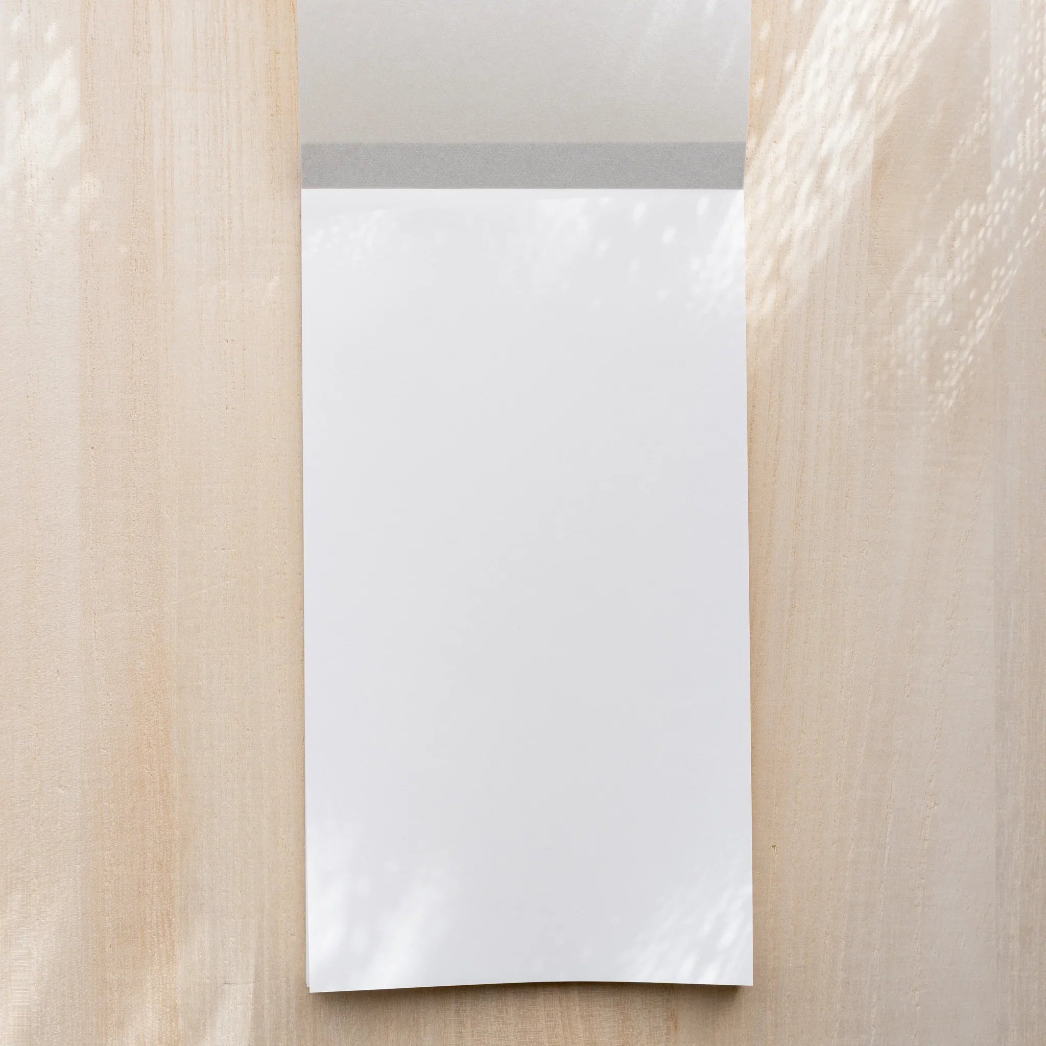 Yamamoto Paper Sanzen Tomoe River S Bullet Paper No.1 notepad opened to first blank sheet with top cloth binding.