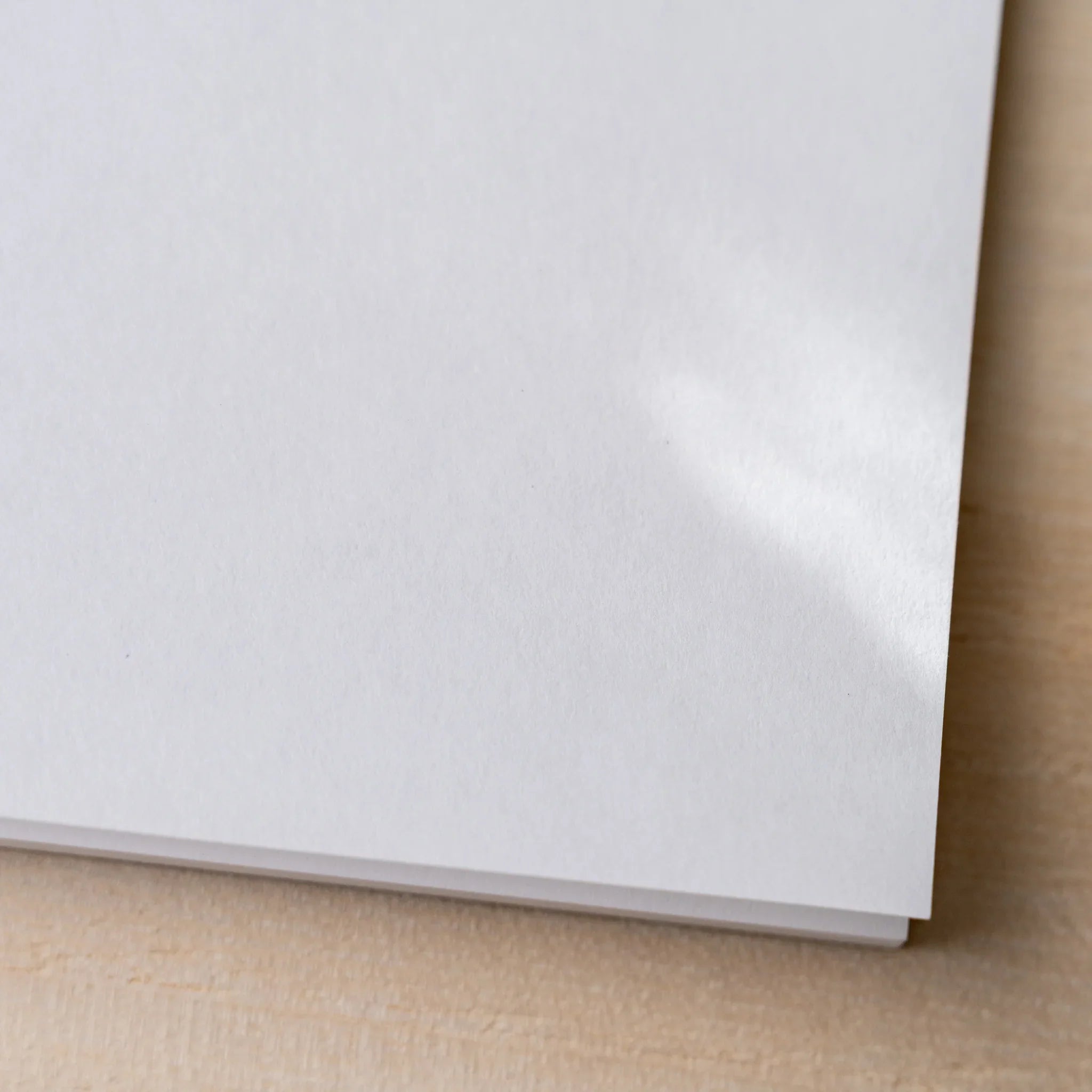 Corner close-up of Yamamoto Paper Sheep Clouds Bond Bullet Paper No.3 Japanese paper stationery notepad.