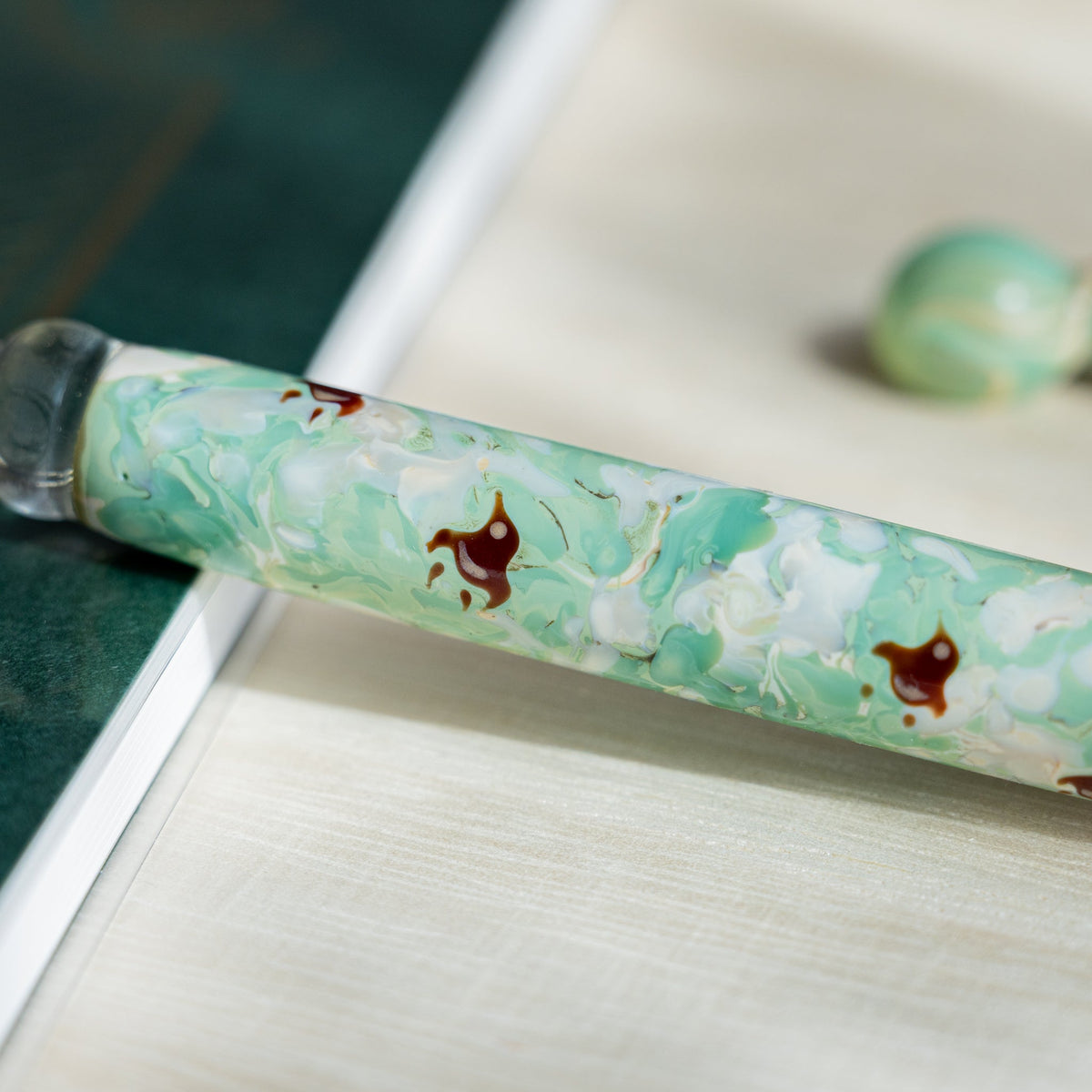 Close-up of the mint marbled barrel showing dark red chidori plover bird motifs