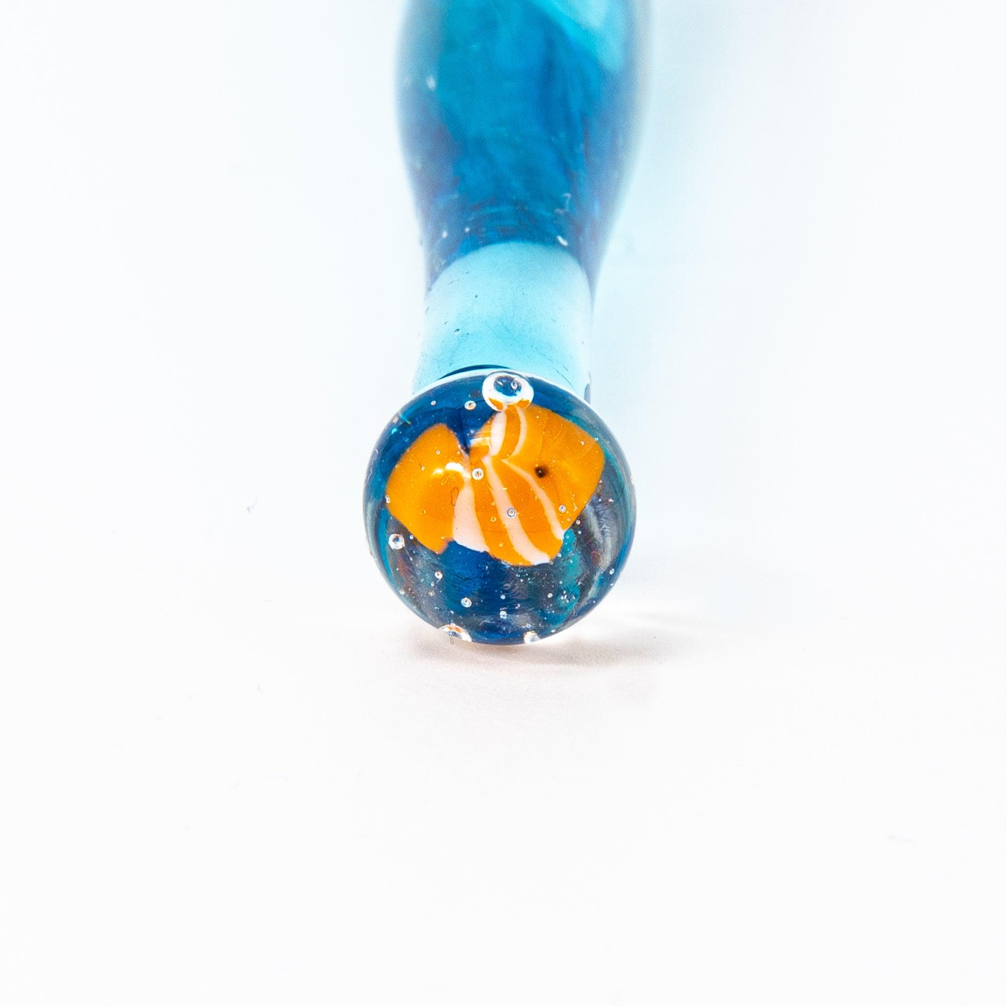 Bottom view of a glass pen with clownfish motif, resembling a miniature aquarium. Ideal for lovers of Japanese stationery.