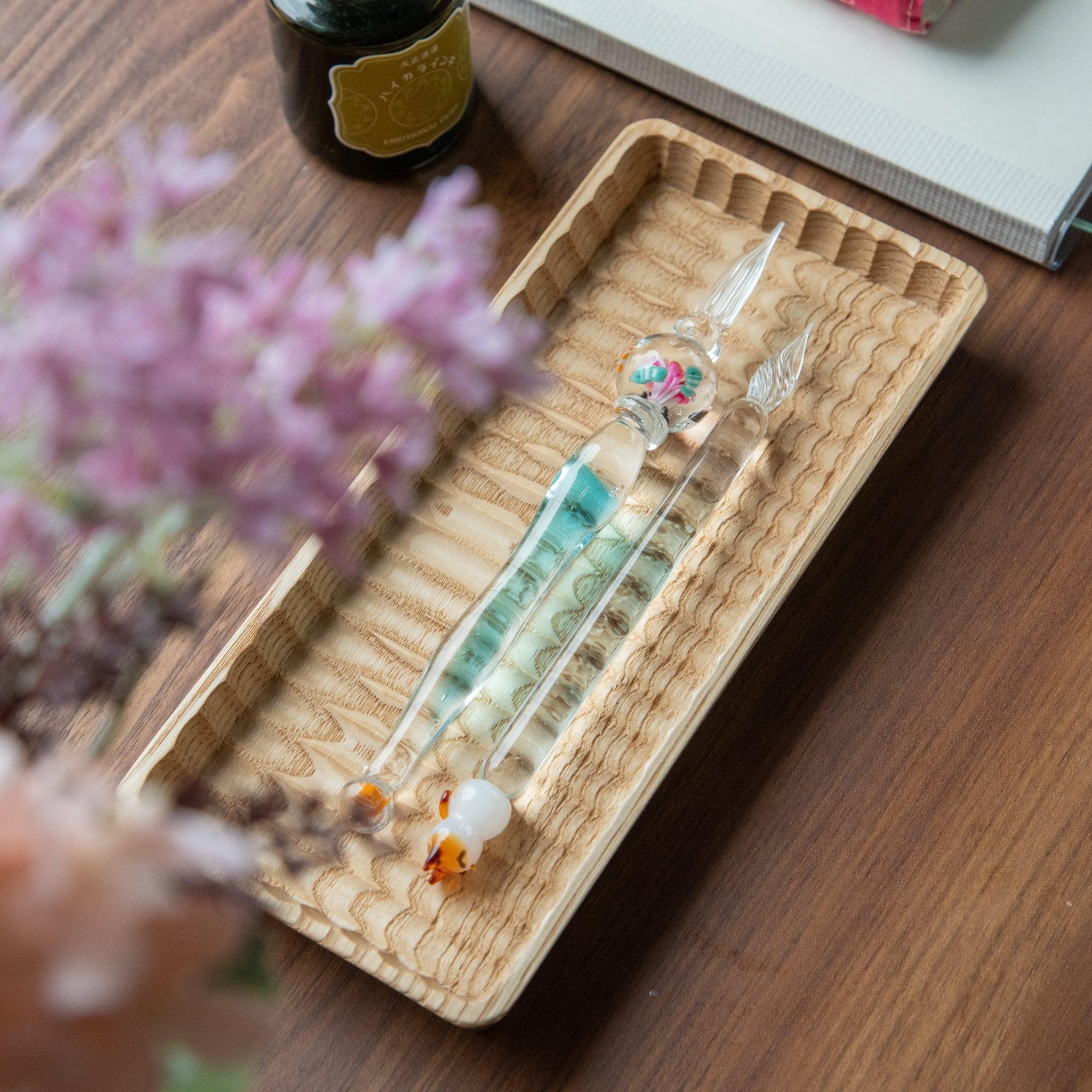 Glass pen with clownfish motif encased in a sphere, resembling a miniature aquarium. Perfect for fans of Japanese stationery.