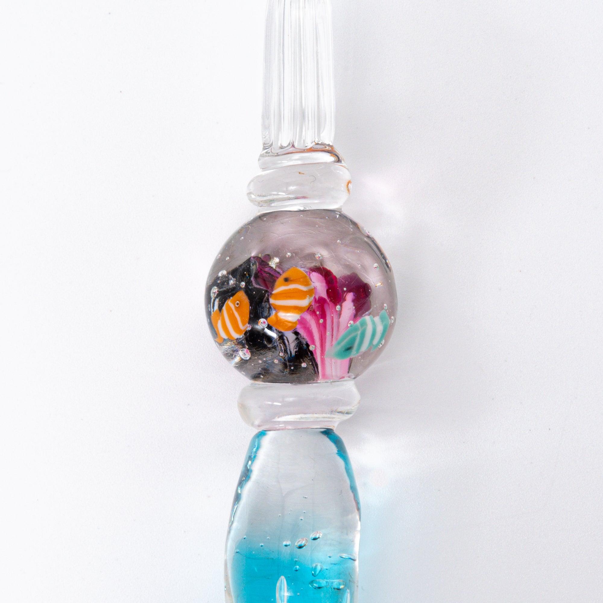 Glass pen with clownfish motif encased in a sphere, resembling a miniature aquarium. Perfect for fans of Japanese stationery.