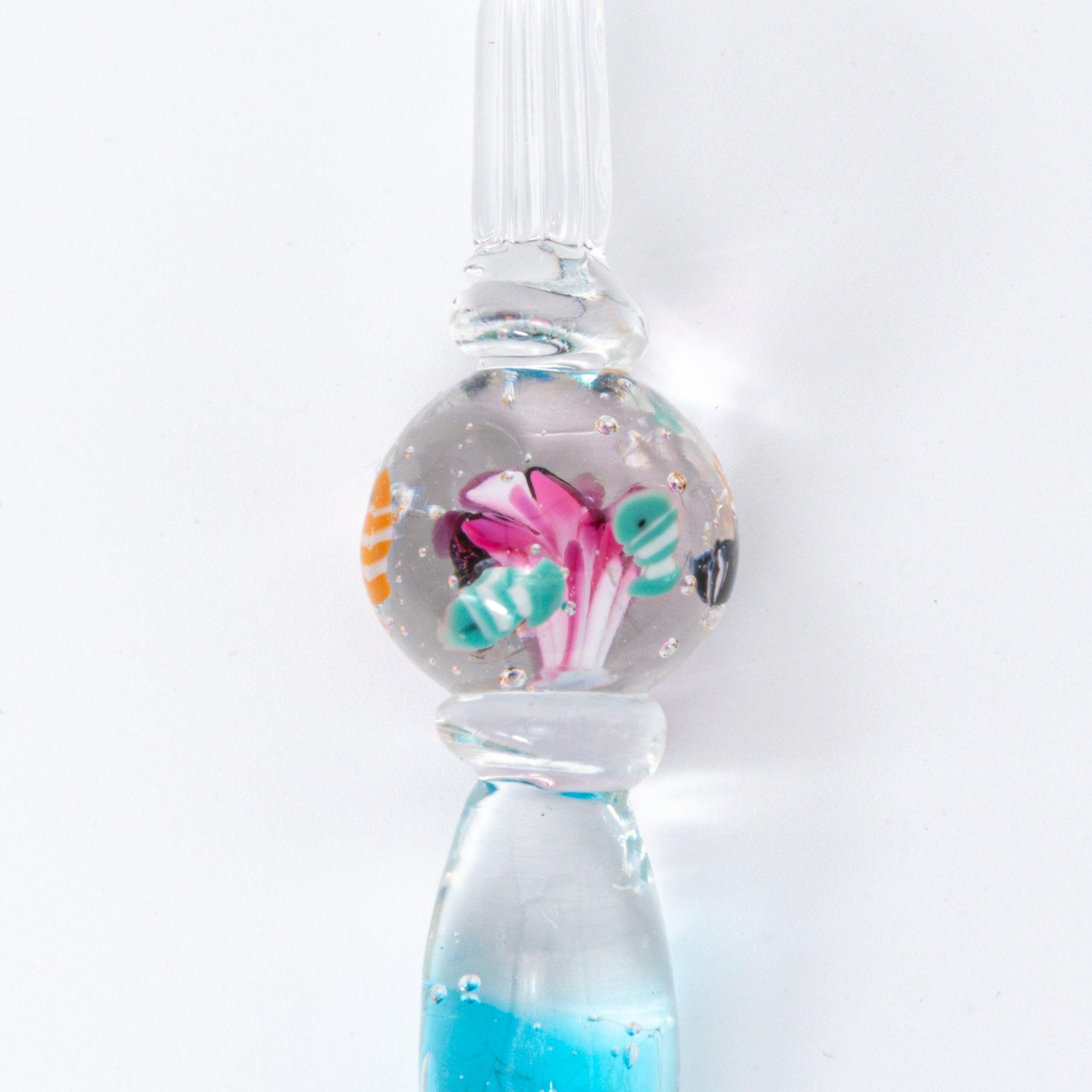 Glass pen with clownfish motif encased in a sphere, resembling a miniature aquarium. Perfect for fans of Japanese stationery.