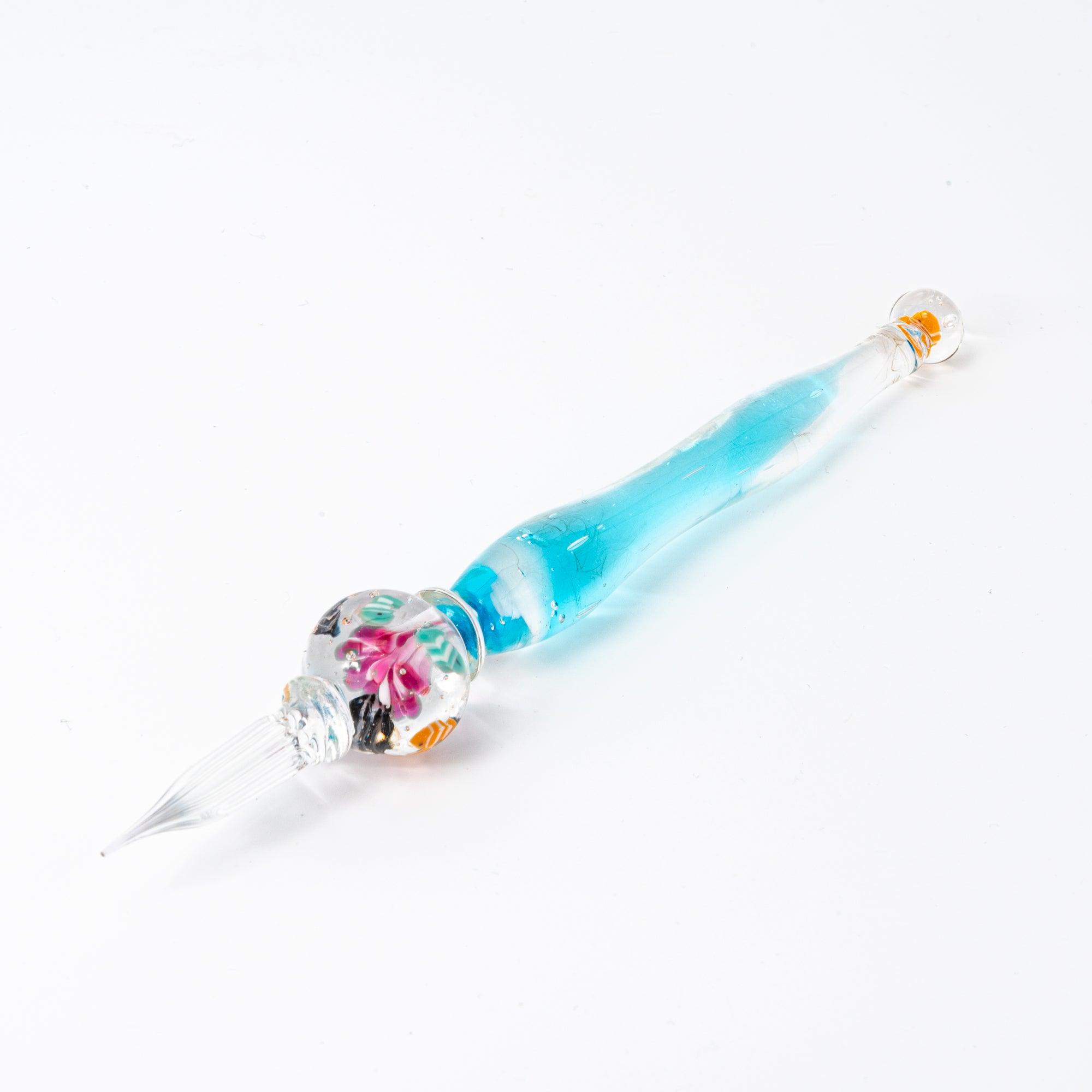 Full view of a glass pen with clownfish and coral motif in a sphere, resembling an aquarium. Great for stationery lovers.