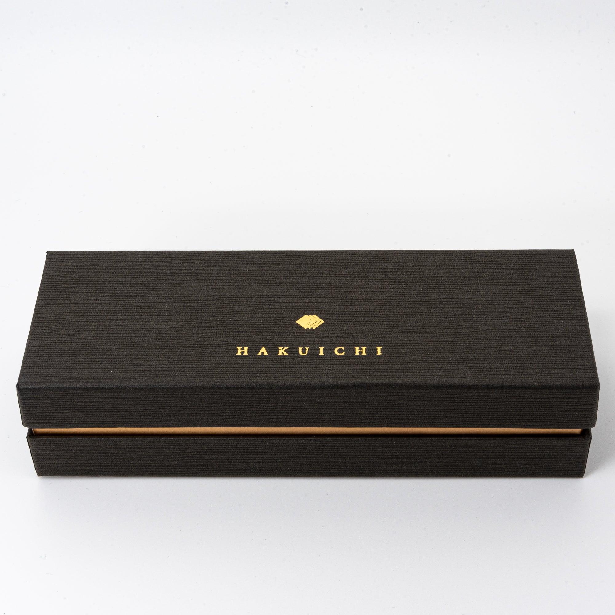 A black box with gold “HAKUICHI” branding, showcasing a minimalist and premium packaging design for the pen.