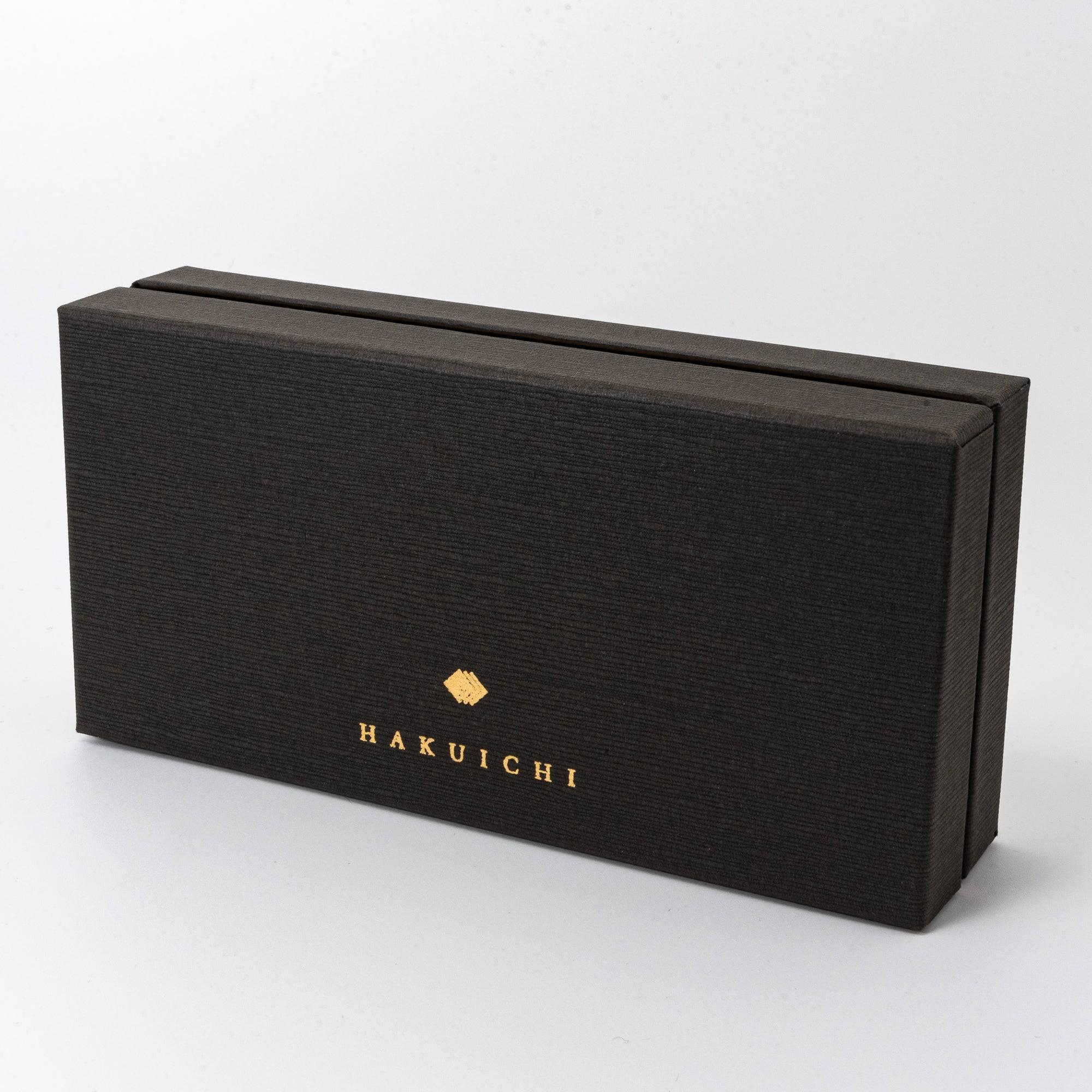 Angled view of the black gift box, showcasing its textured finish, gold "HAKUICHI" logo, and refined minimalist design.