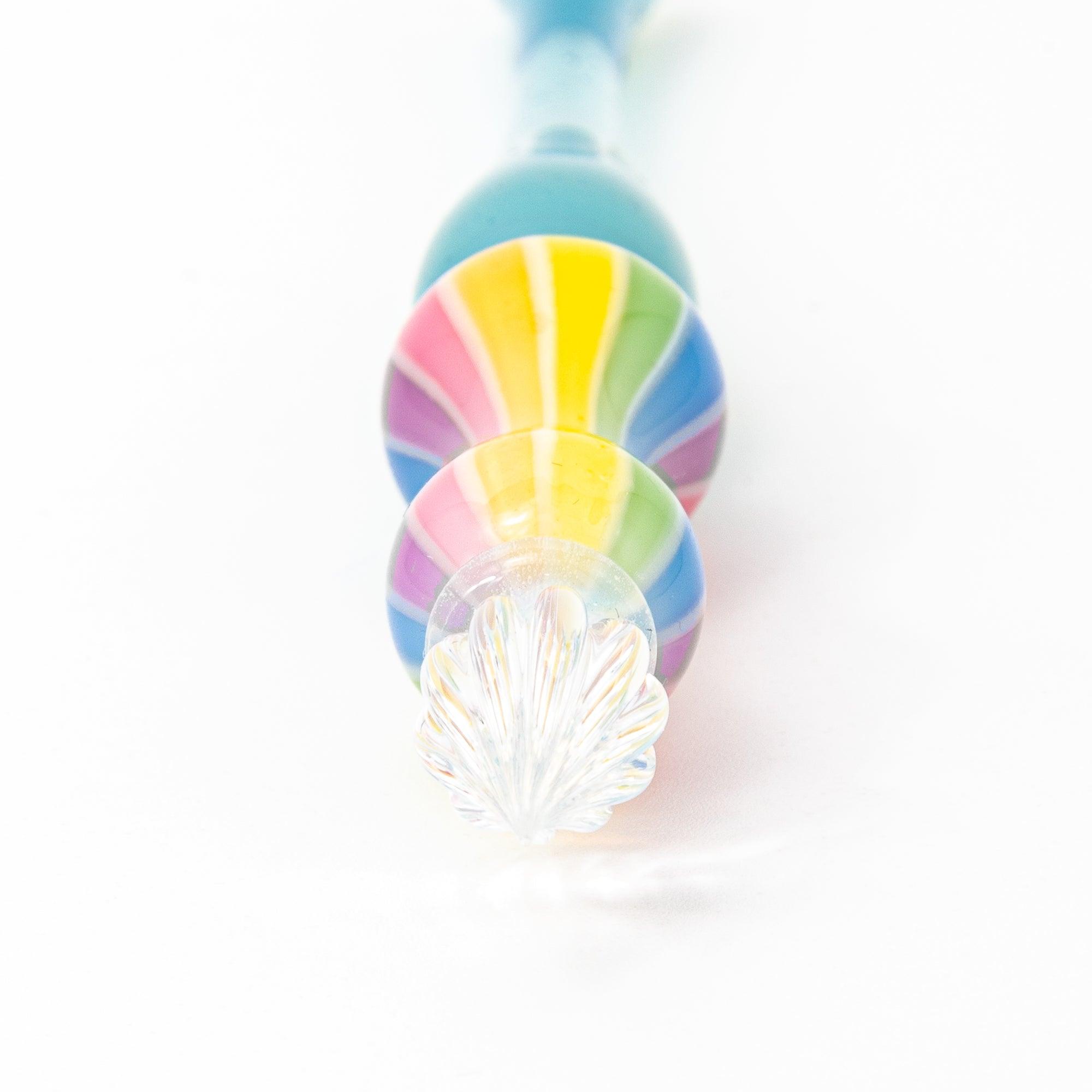 Rainbow balloon glass pen with a blue handle, photographed on a white background. Perfect for Japanese stationery and glass pen enthusiasts.