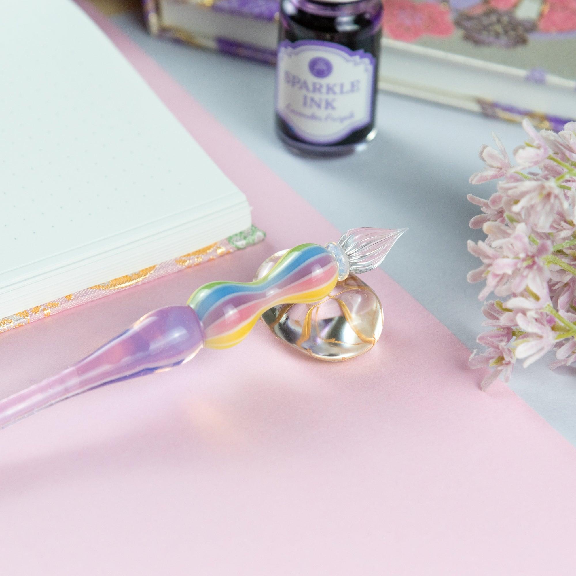 Hand writing with a glass pen featuring a rainbow-colored handle. Ideal for fans of Japanese stationery.