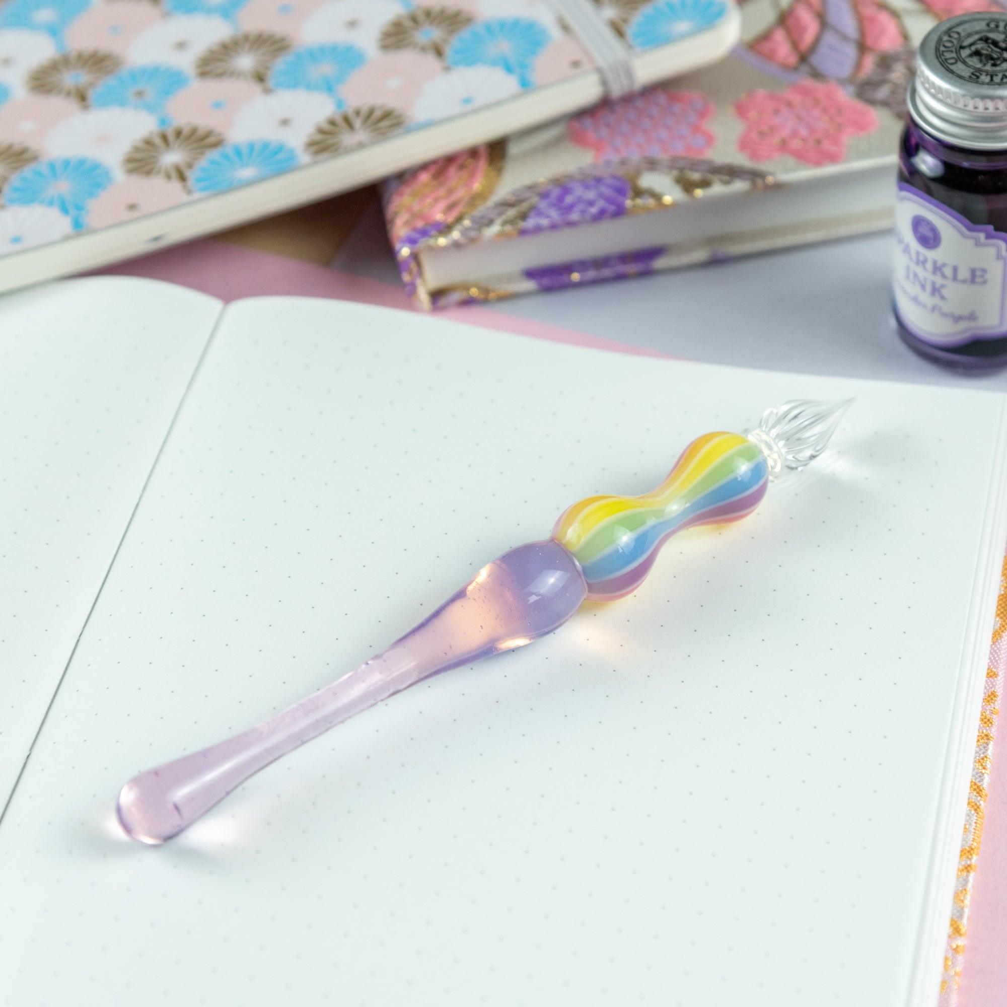 Full view of a glass pen with a rainbow-colored handle on a white background. Ideal for collectors of Japanese stationery.